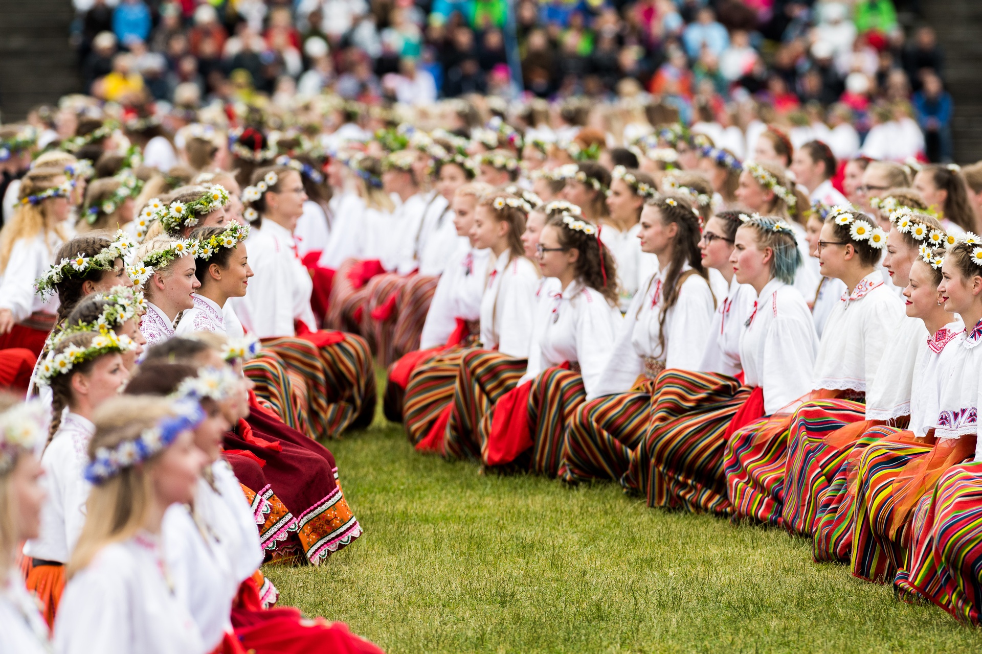 Estonian dancers in traditional red striped skirts