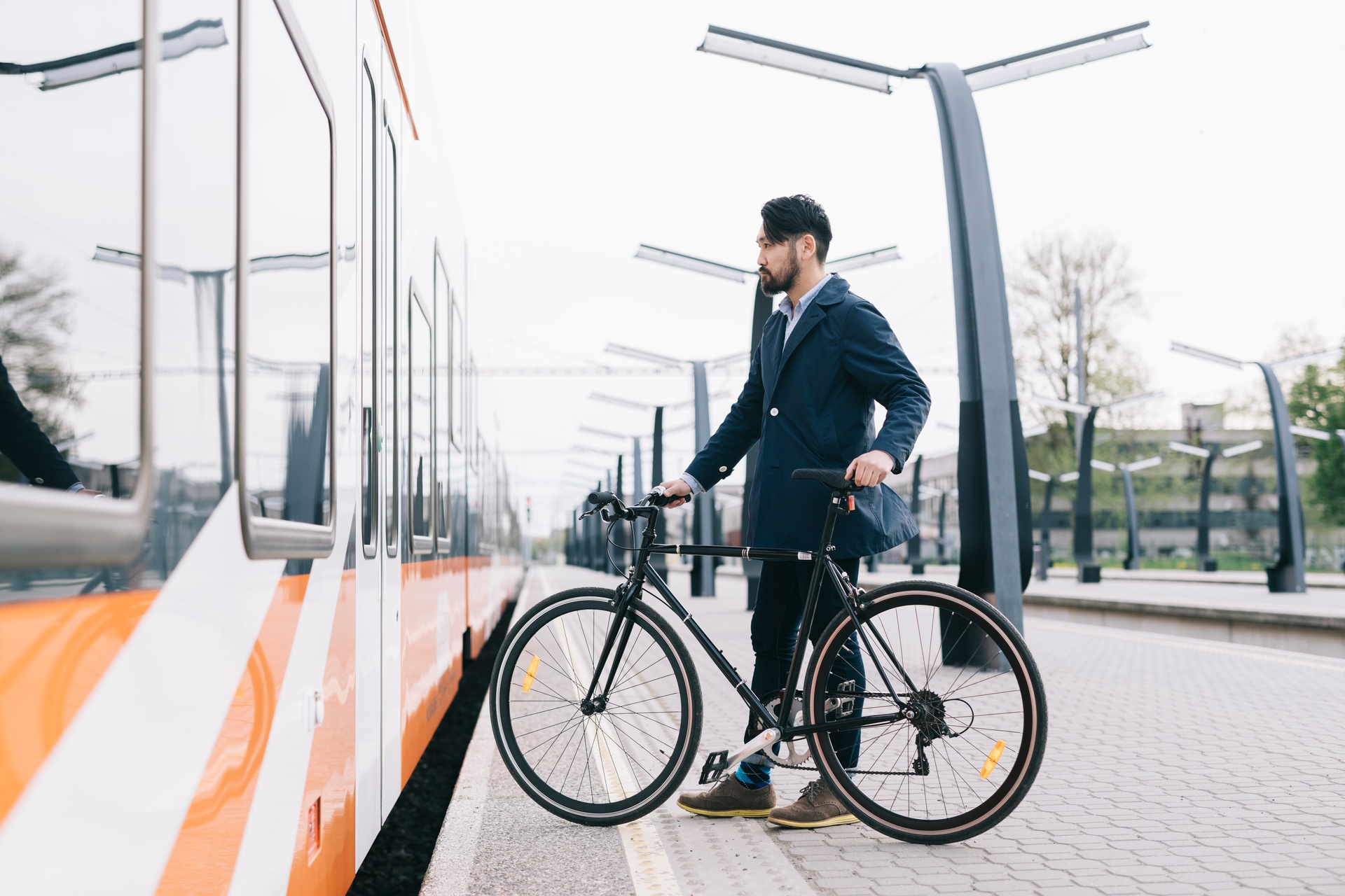 Man getting on a train with bike