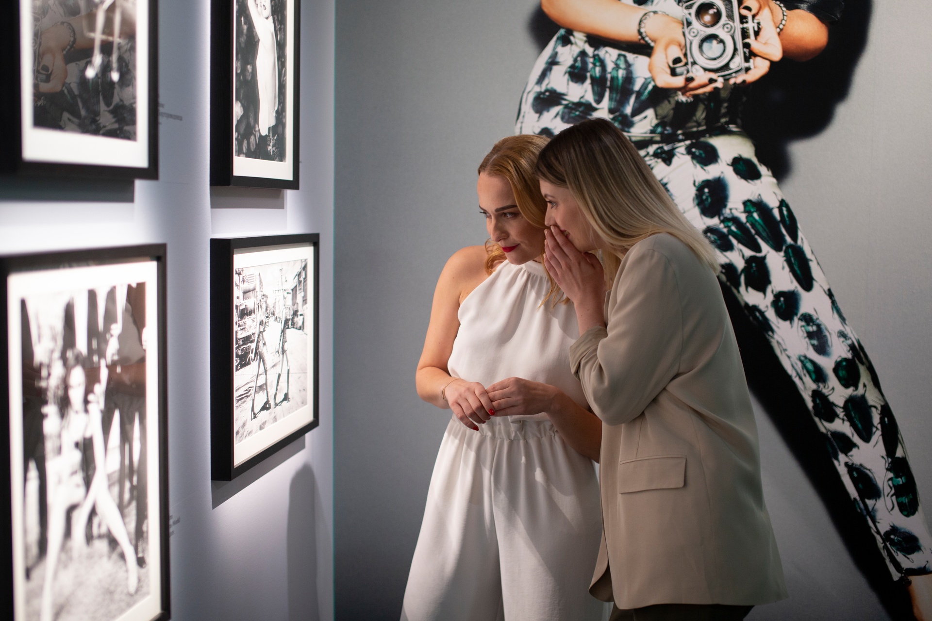 Women look at black and white photos at Fotografiska Tallinn