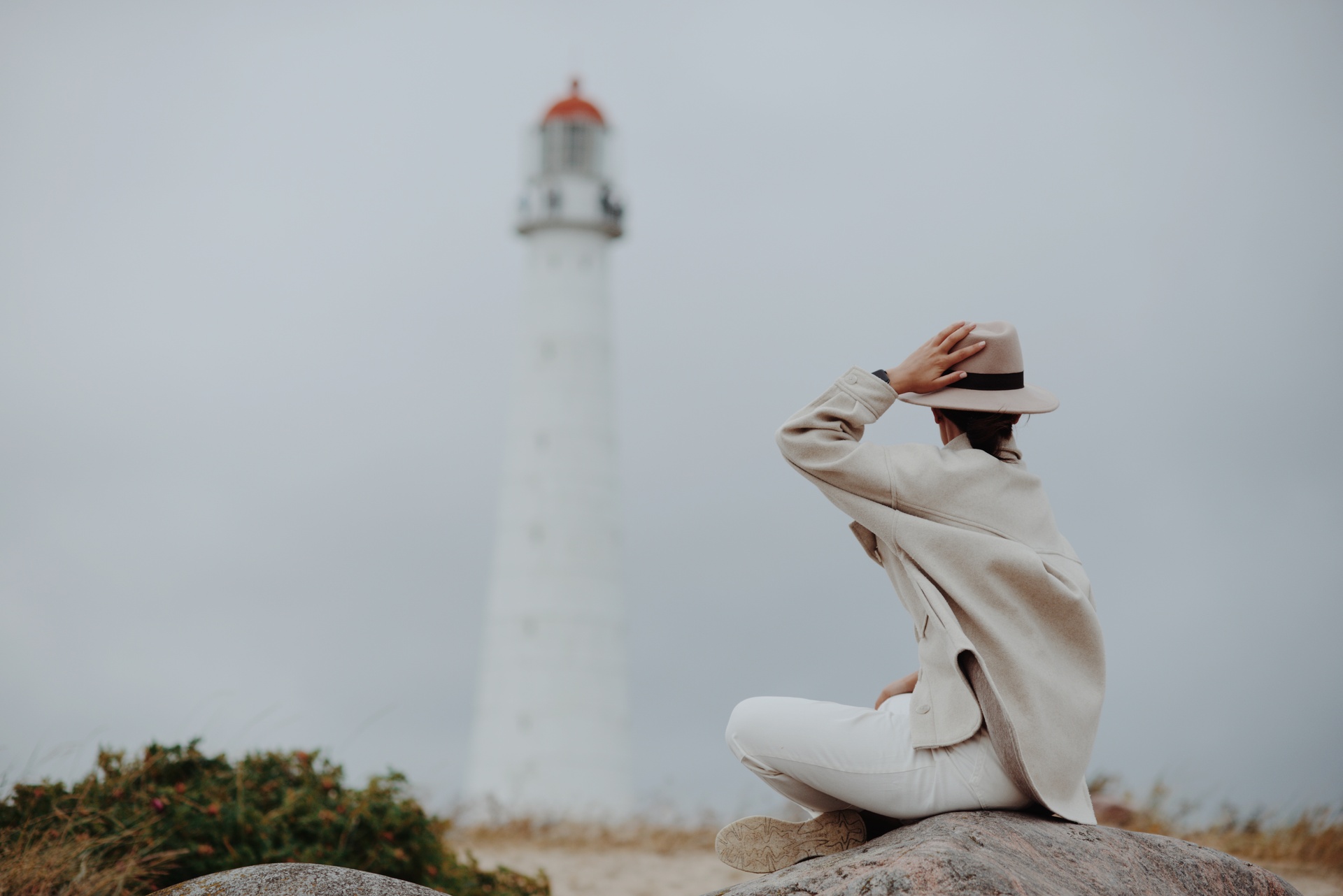 A woman sitting near Tahkuna lighthouse in Hiiumaa