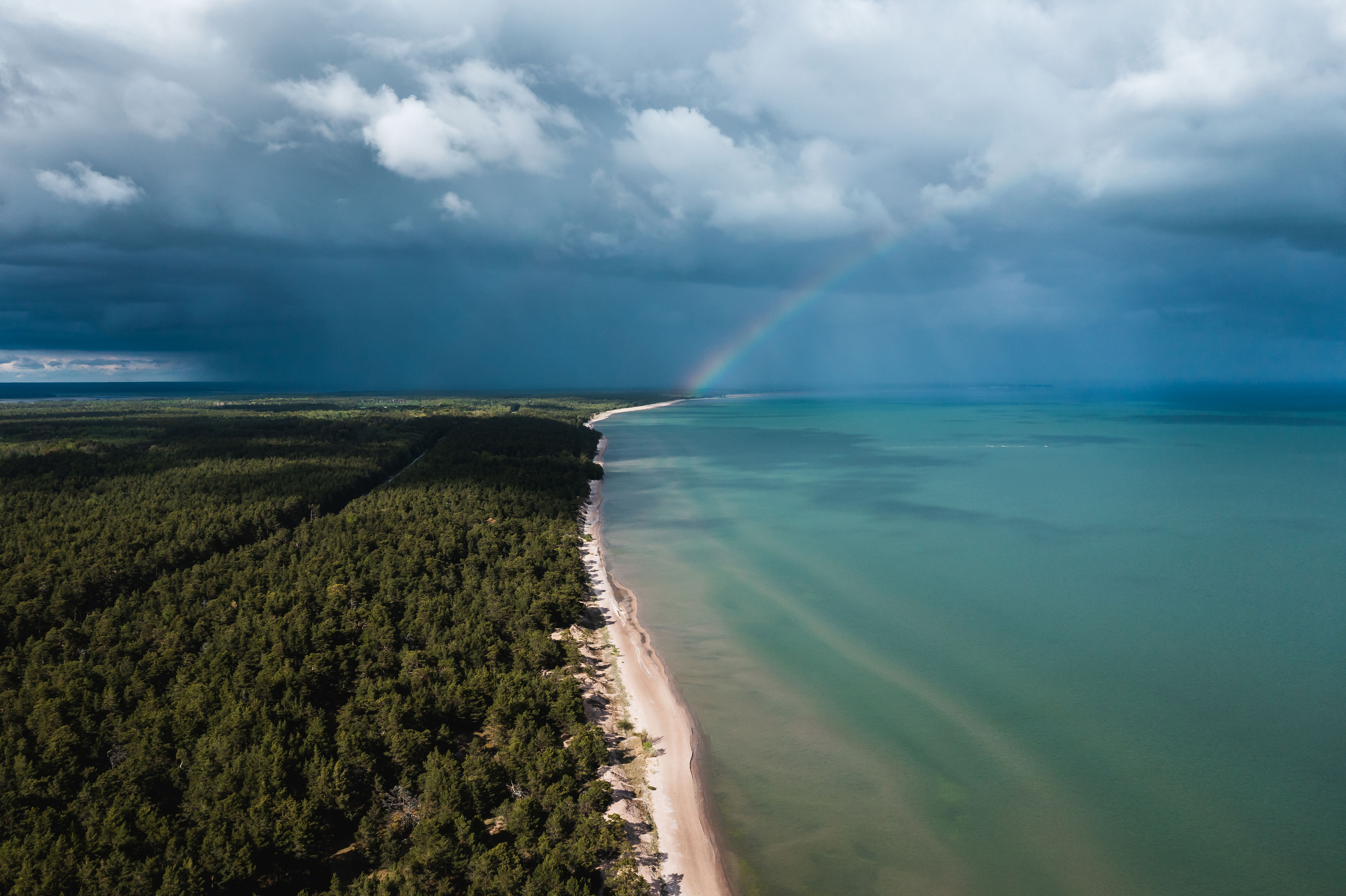 Rainbow over long sandy beach in Estonia