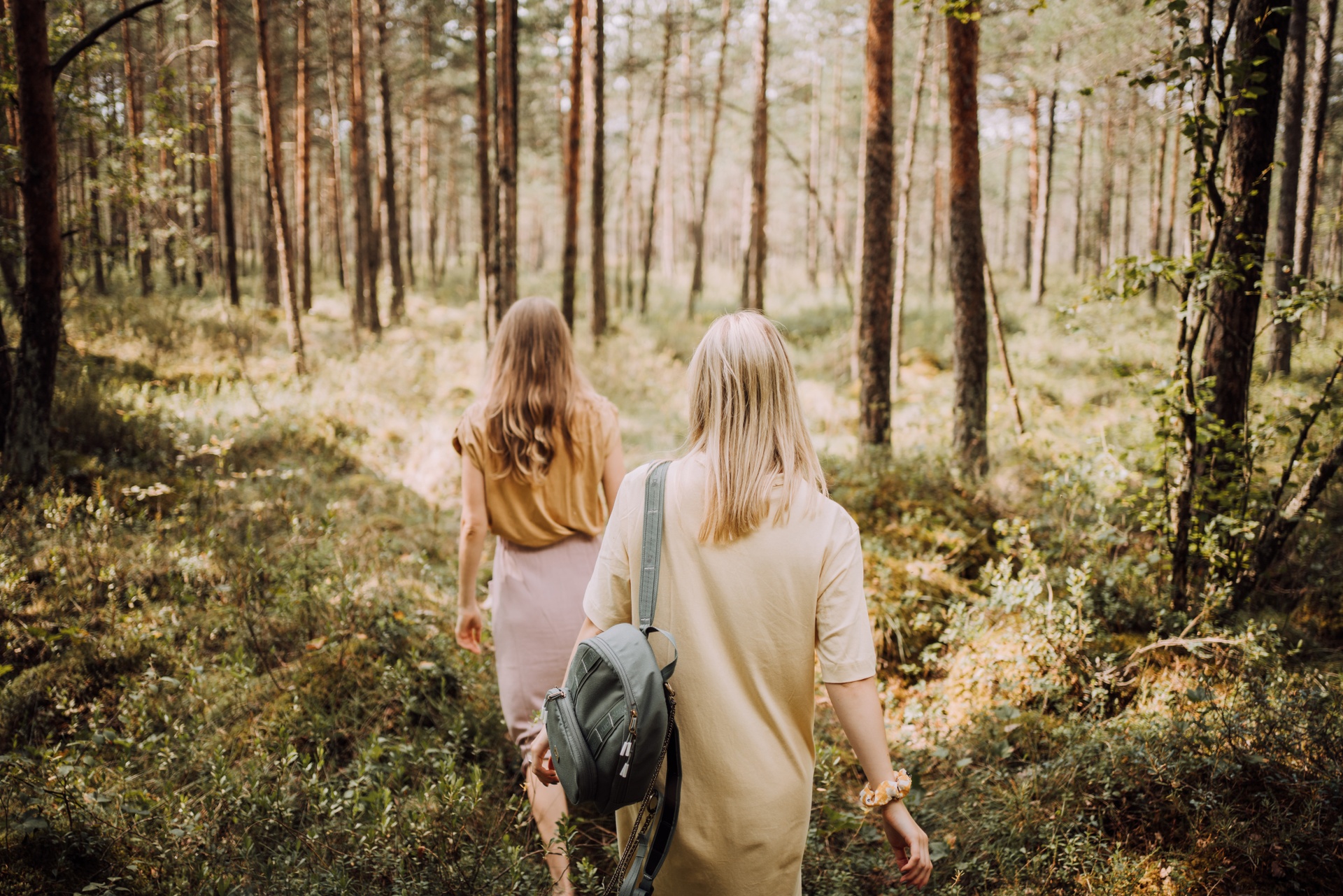 2 women walking in the forest