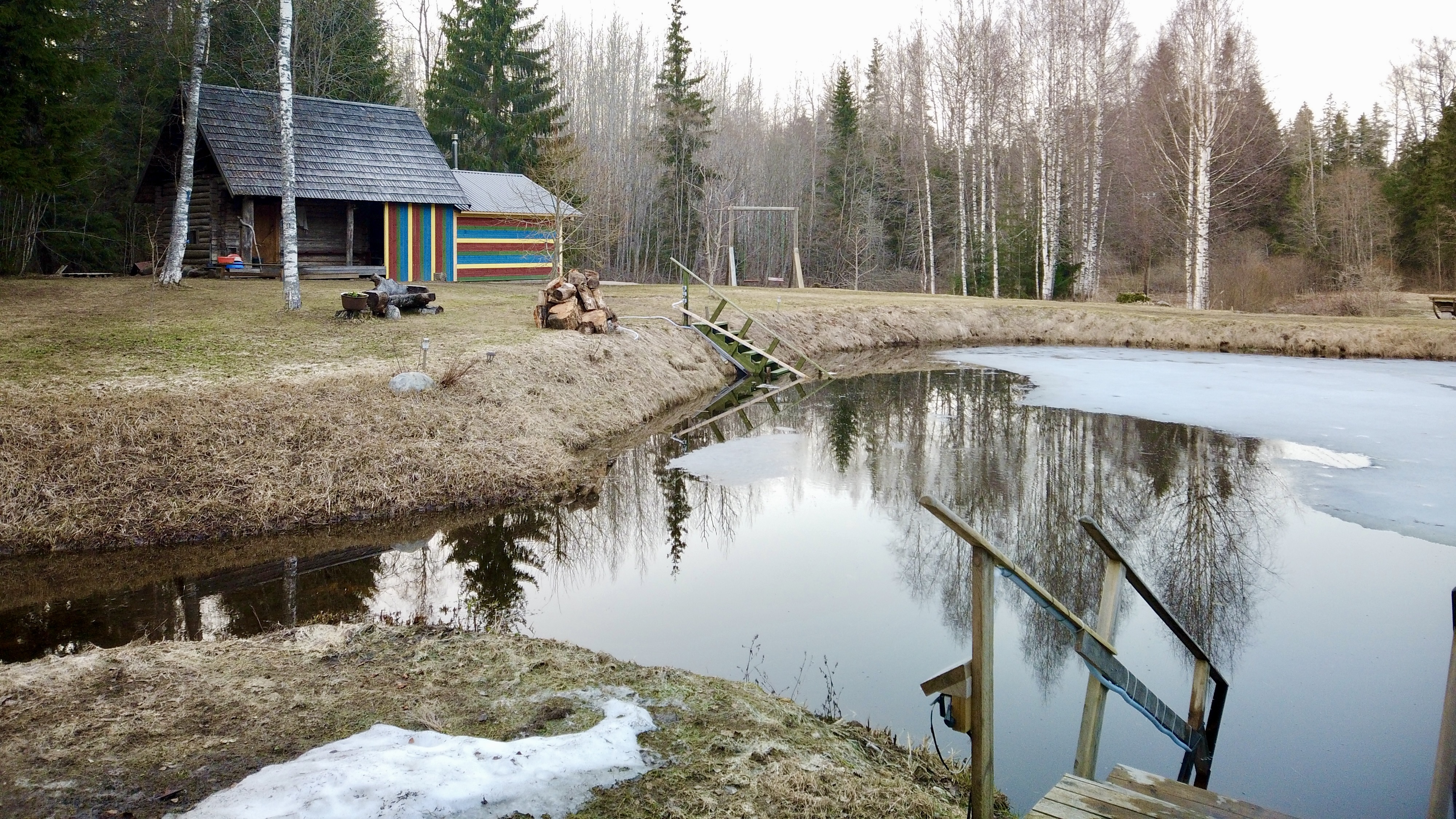 Mooska smoke sauna during the early spring with frozen pond