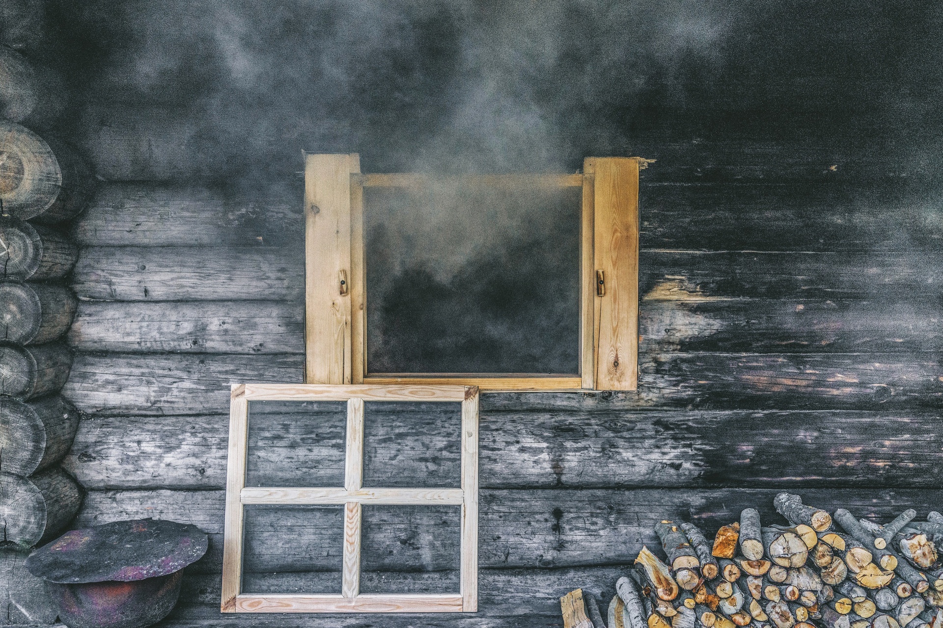 Smoke exiting a window of a smoke sauna in South Estonia