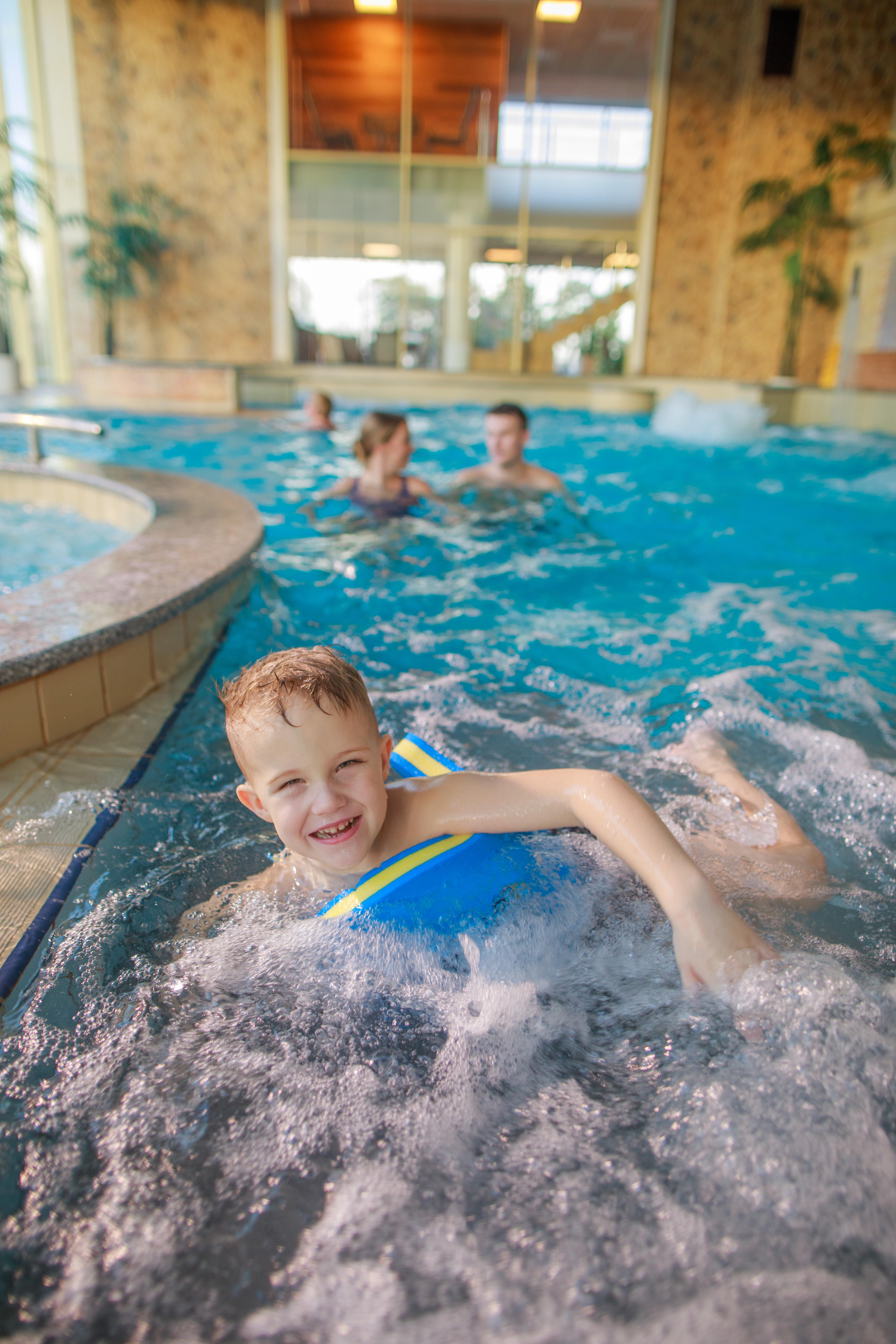 Happy boy floating in the pool at Toila Spa Hotel in Estonia