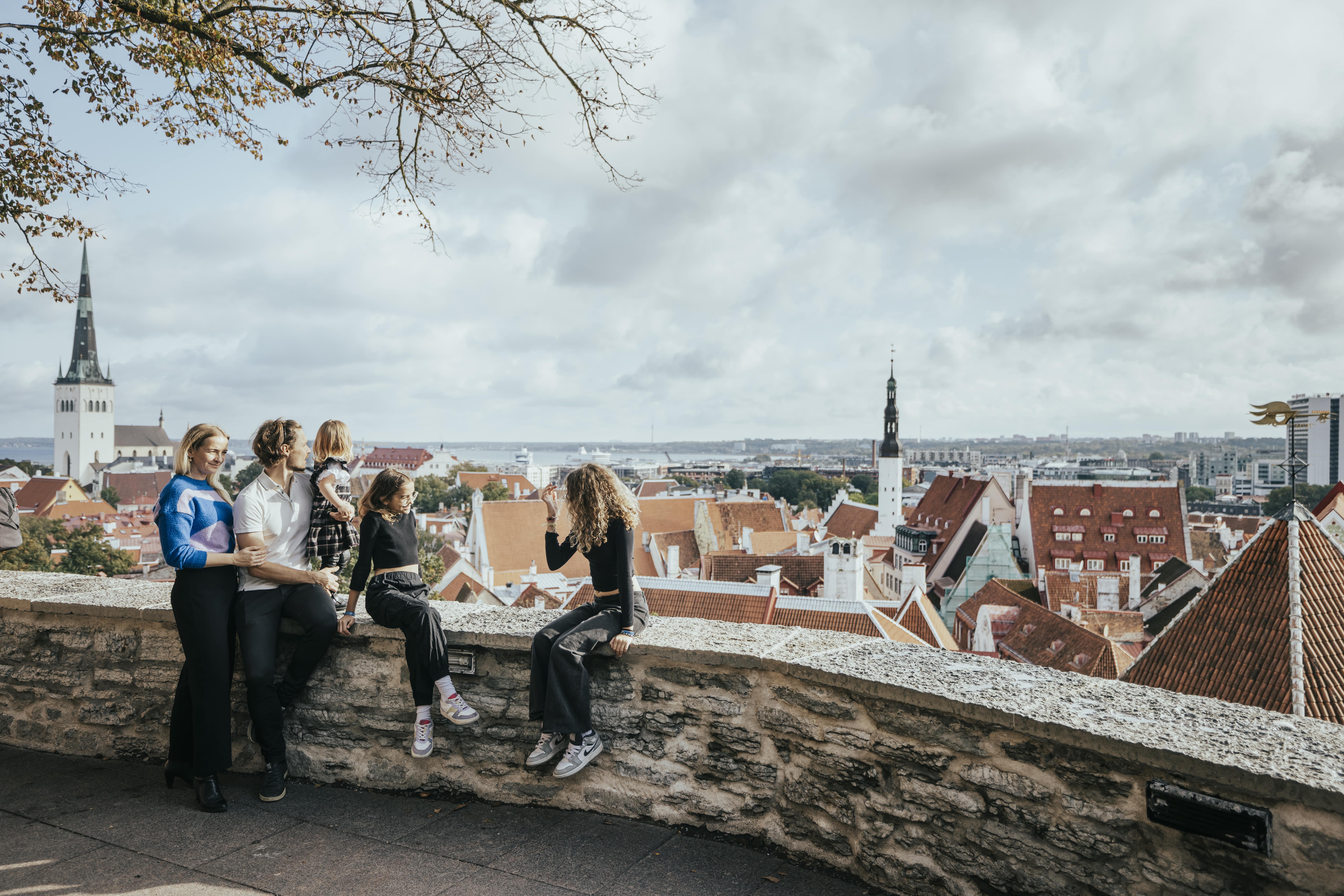 Family with three children looks out over Tallinn's skyline