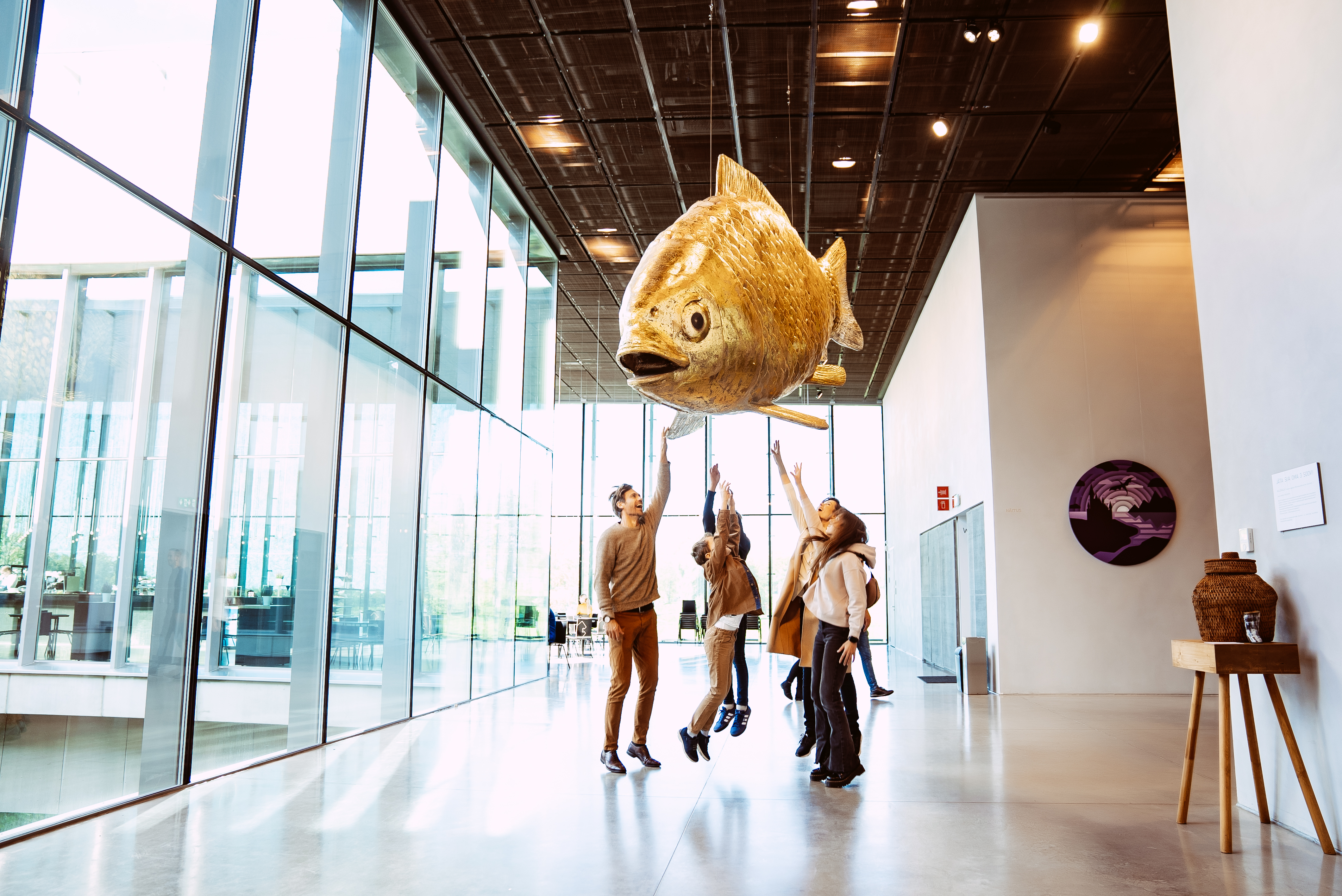 Family jumps to touch sculpture at Estonian National Museum