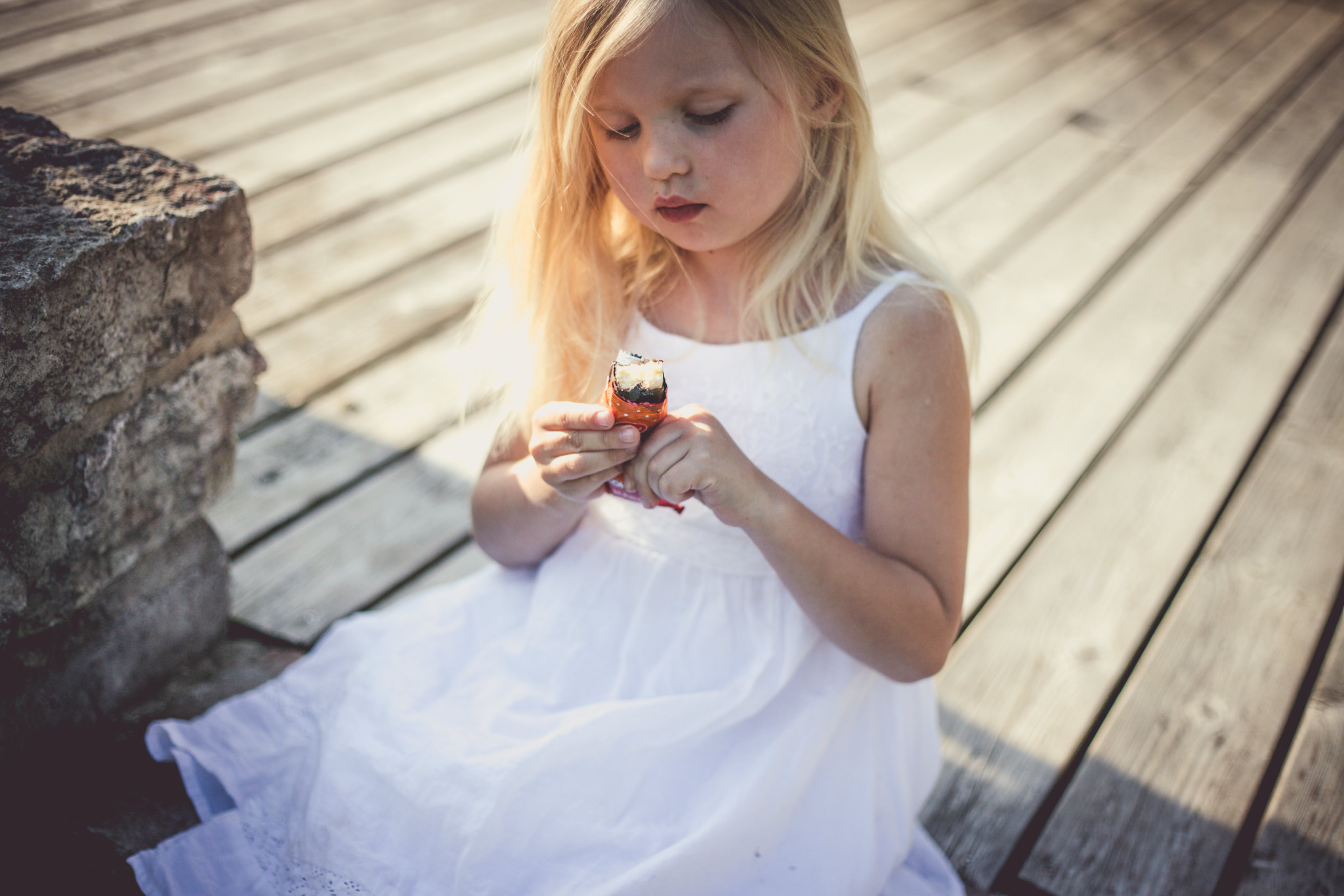 Little girl eating kohuke cheesecake snack in Estonia