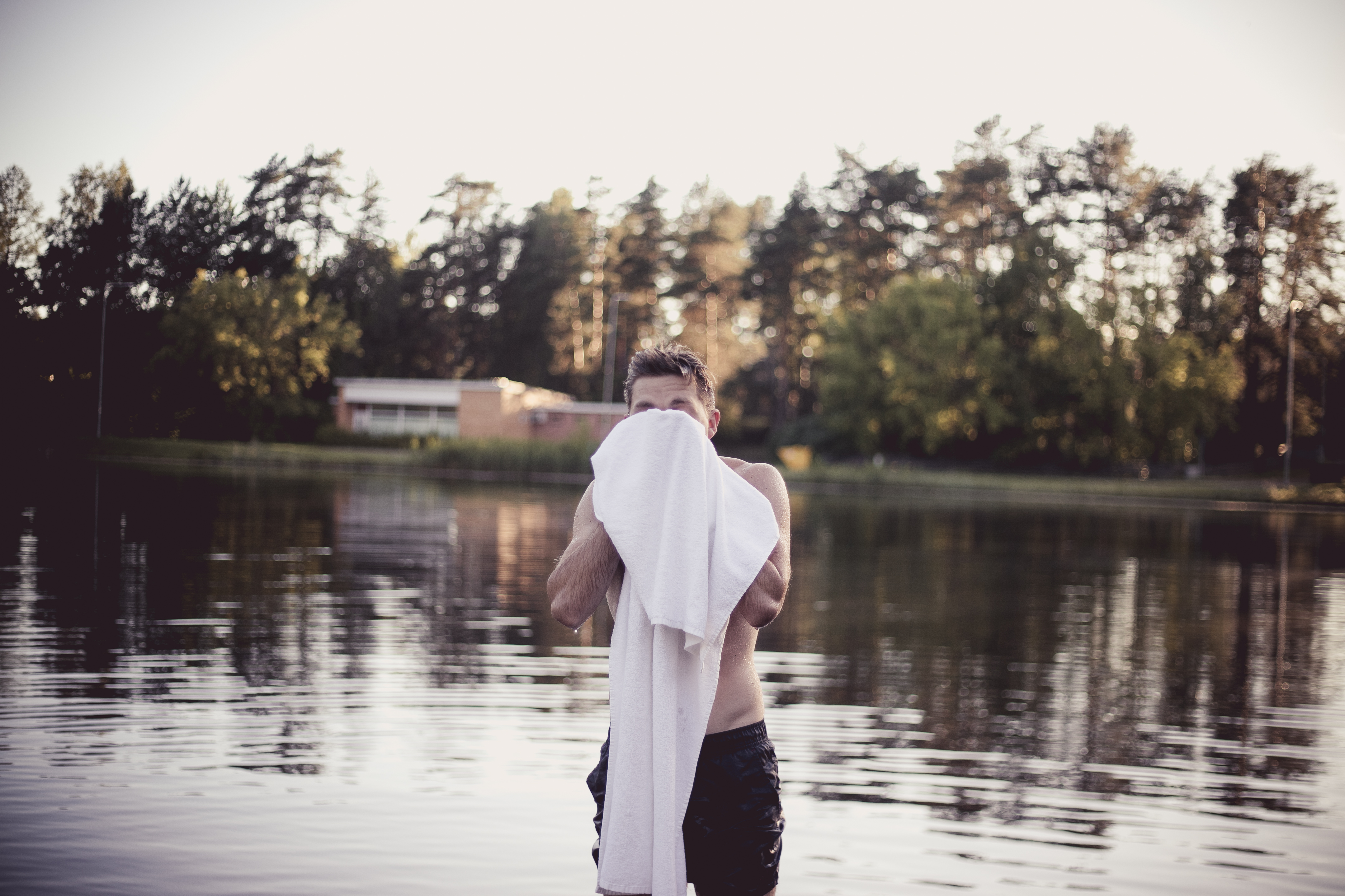 Man drying off with towel after swimming in Estonia