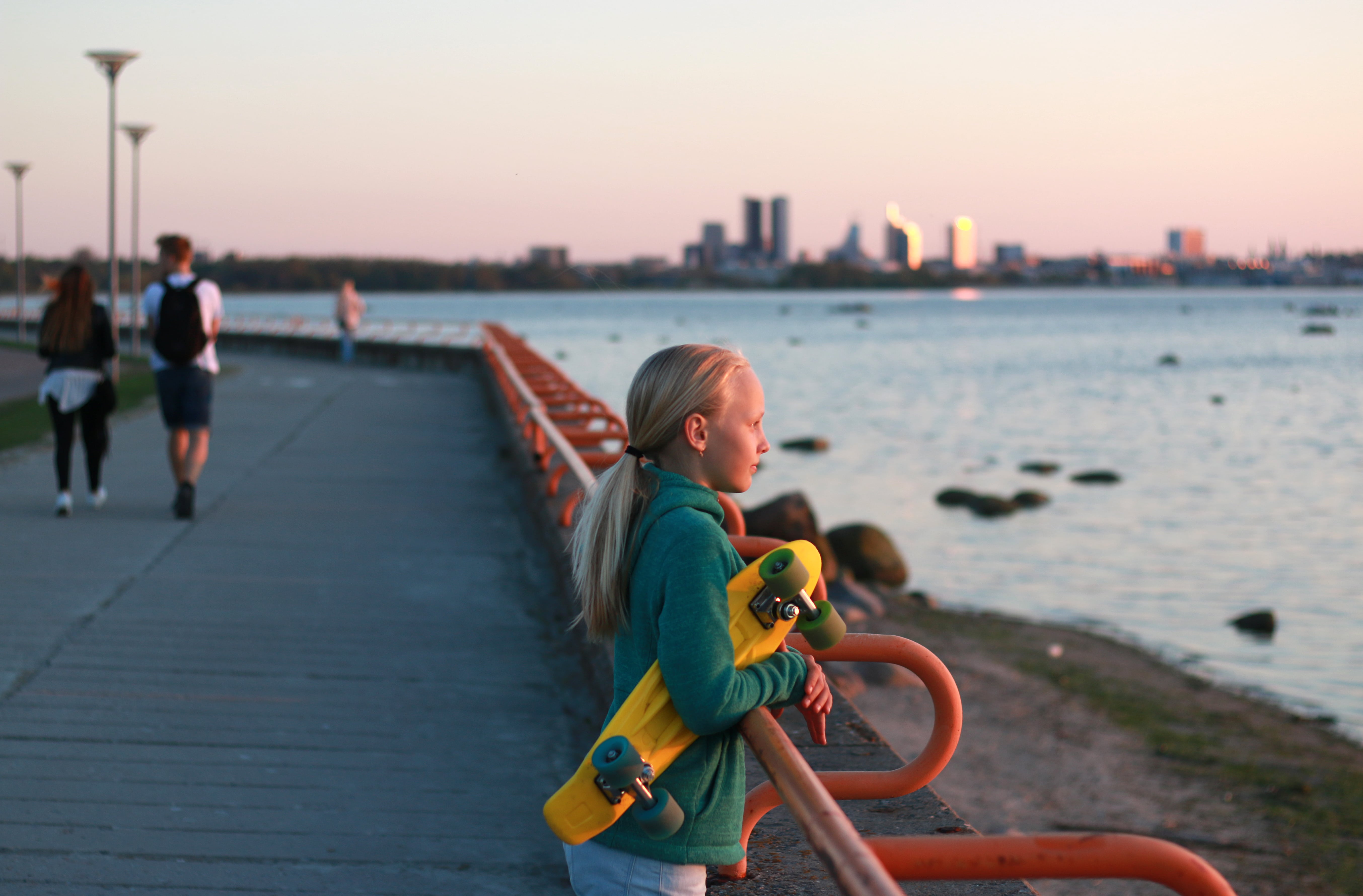 Girl watches sunset from Pirita Promenade in Estonia