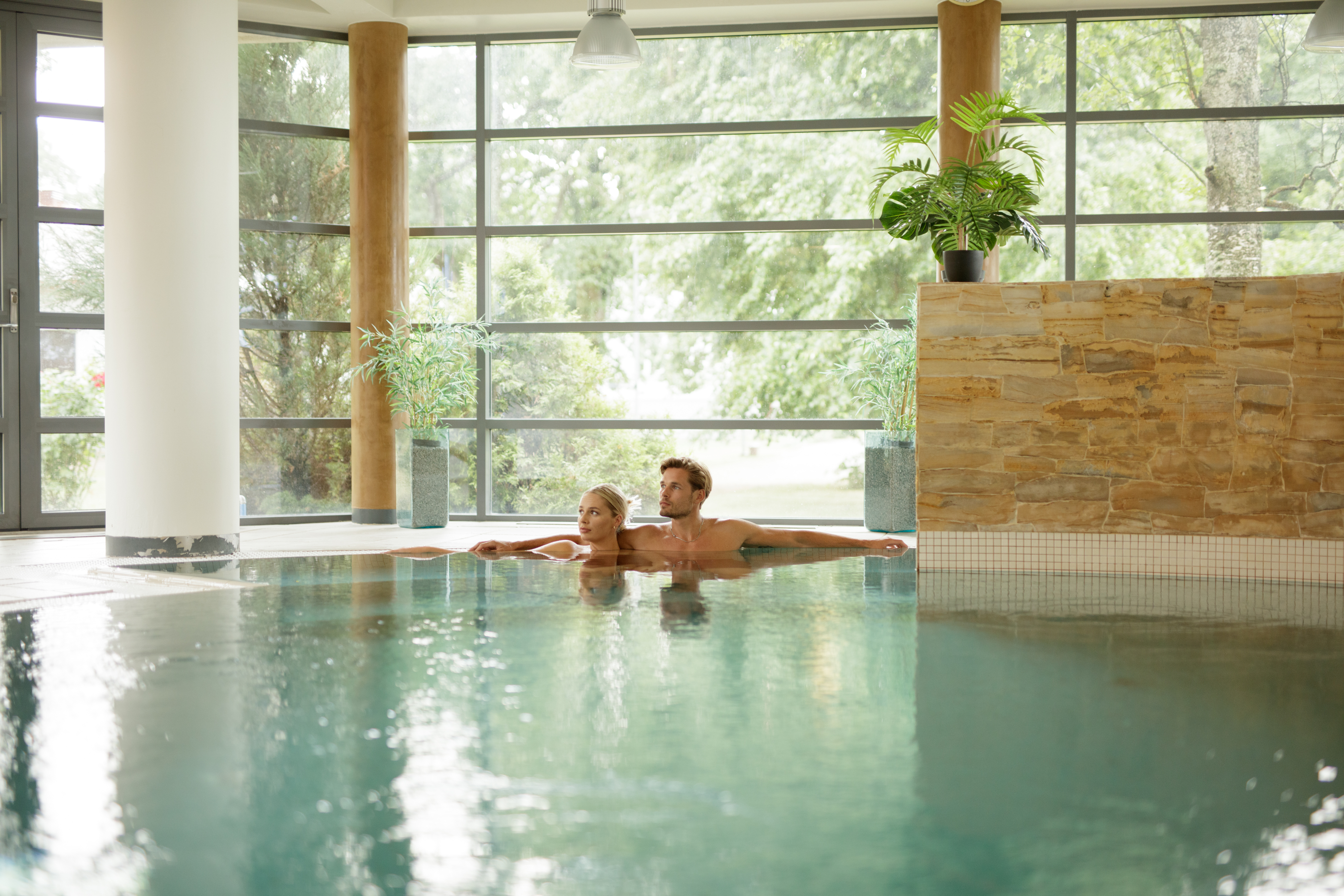 Couple relaxes in indoor pool at Saka Manor Spa