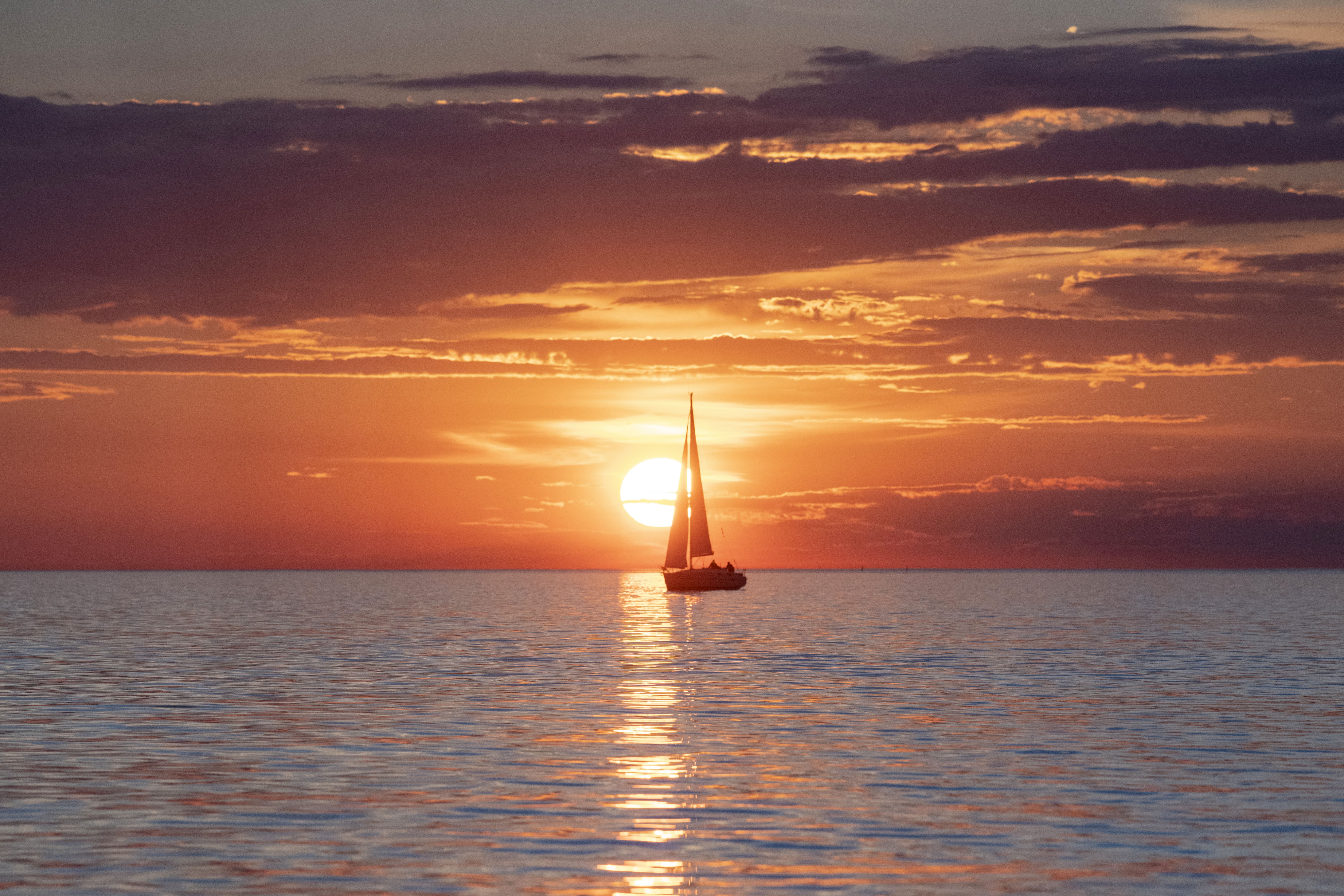 Sunset over Tallinn Bay with sailboat