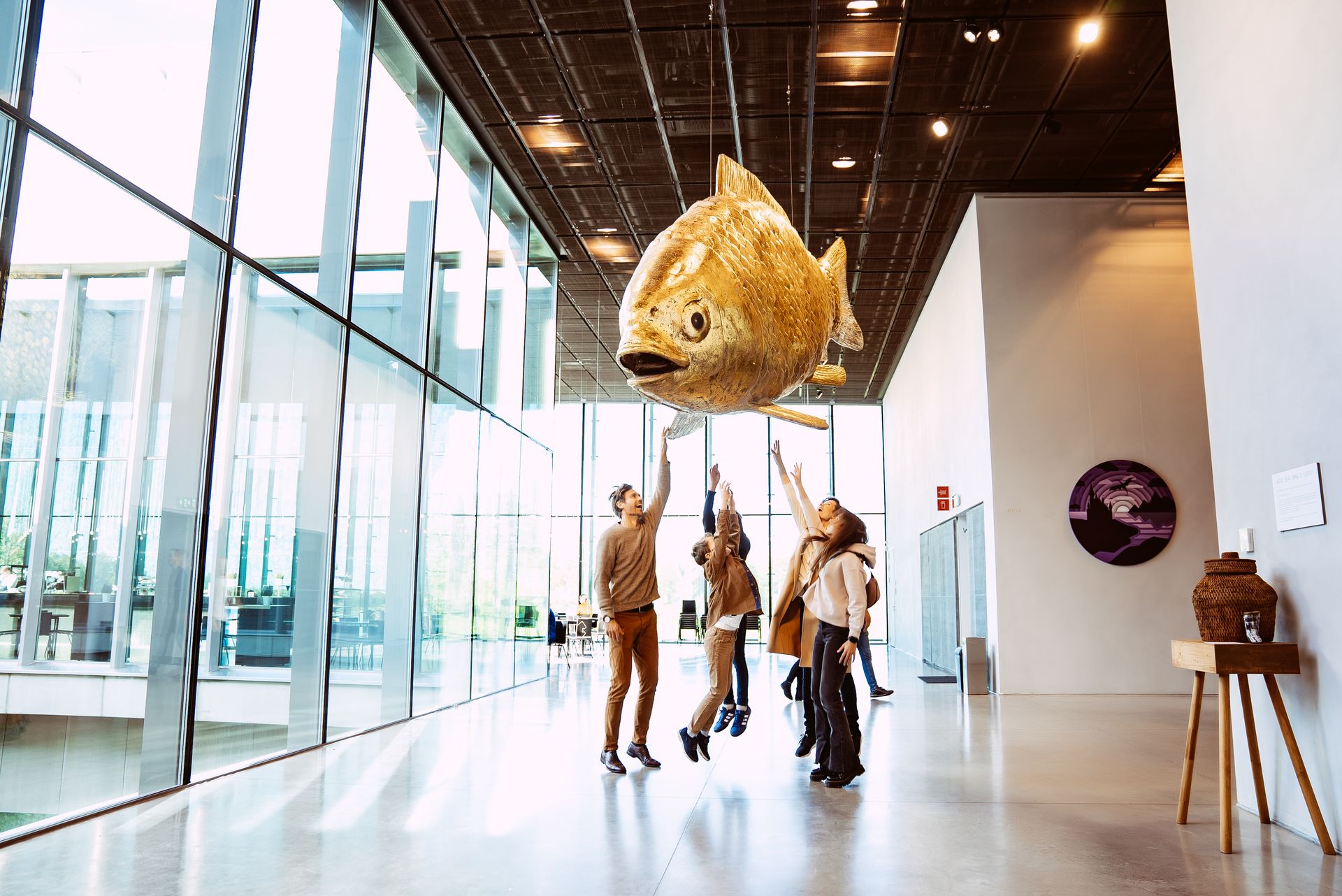 Estonian National Museum family jumping up to touch fish