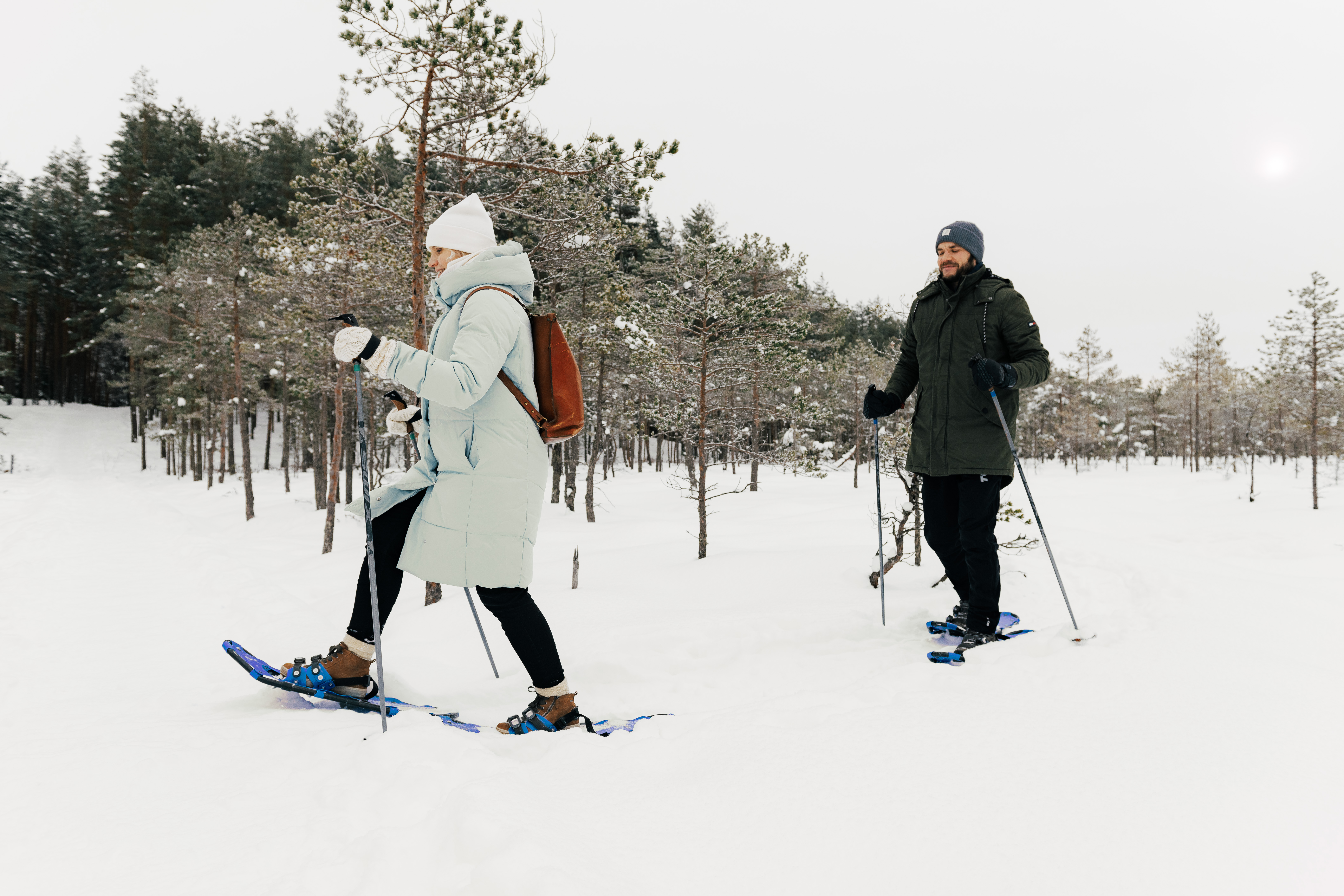 Couple snowshoeing in the bog in winter in Estonia