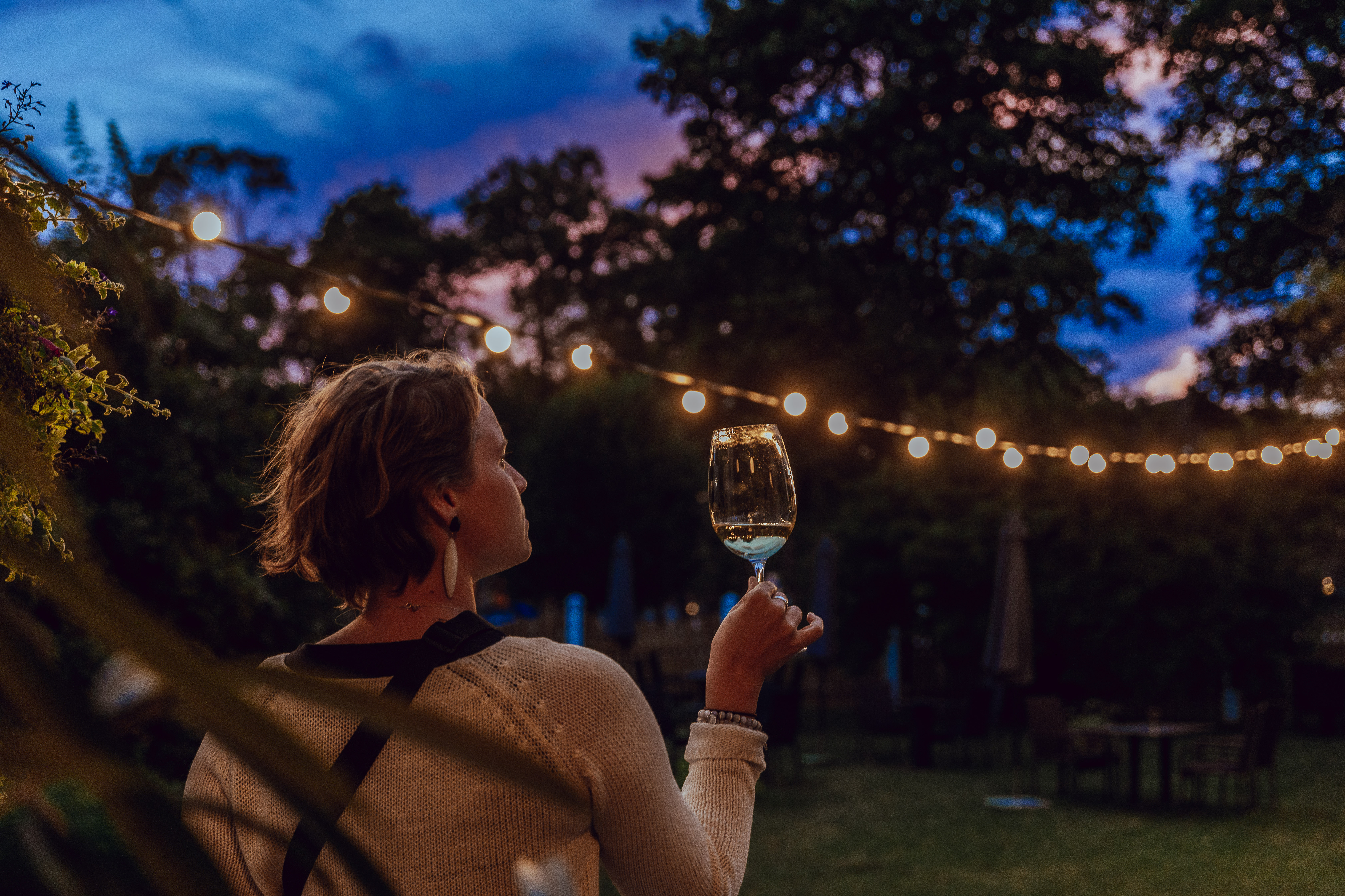 Woman enjoys glass of wine in the evening at Villa Maria