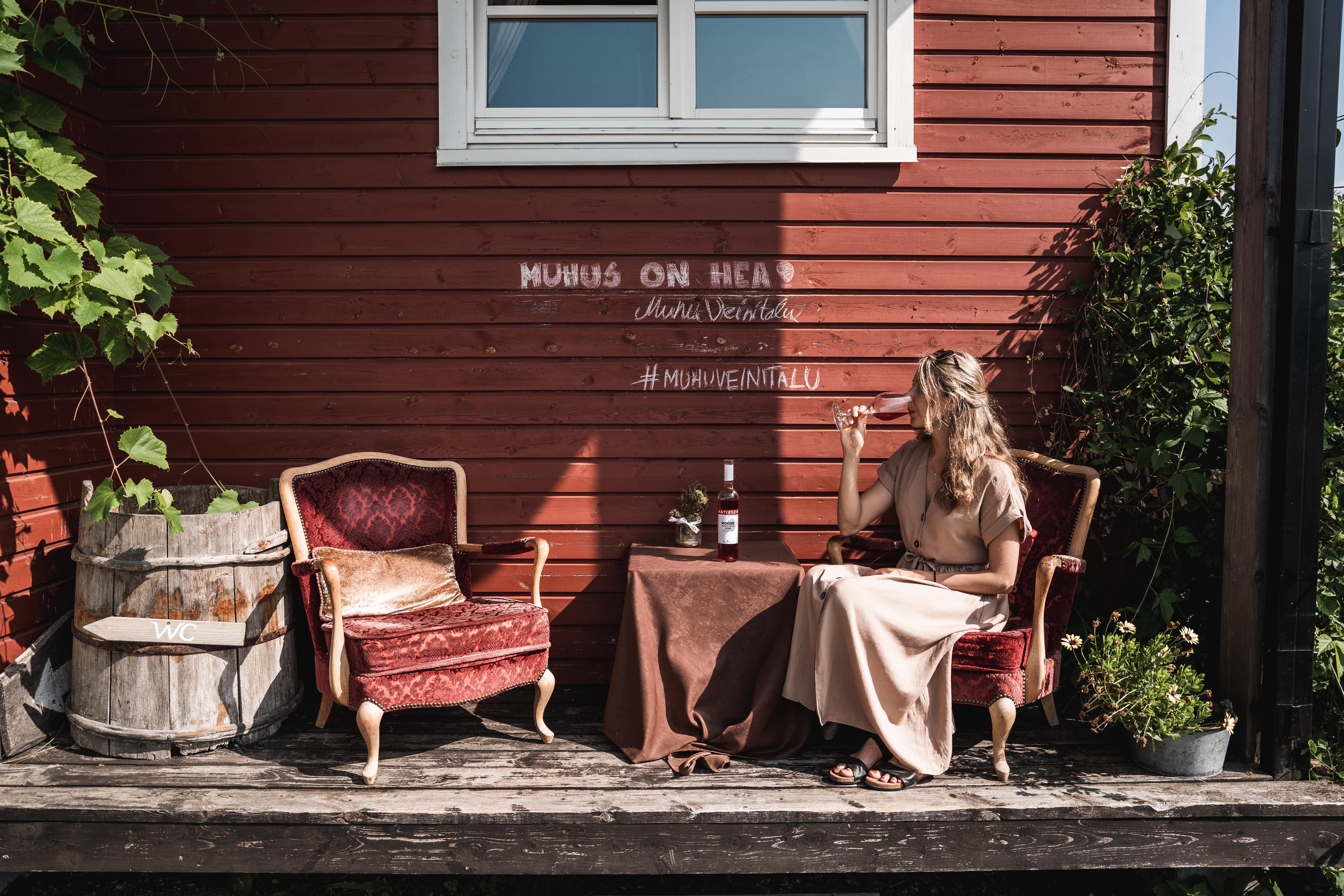 Woman drinking wine at Muhu Winehouse in Estonia