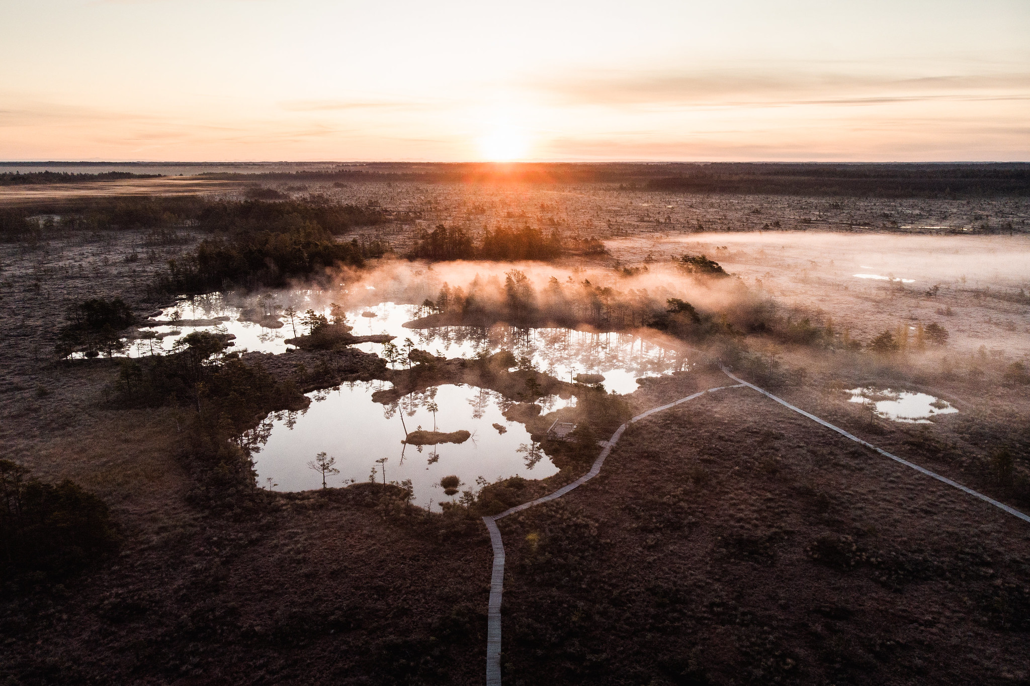 Tolkuse Bog and hiking trail and misty morning sunrise