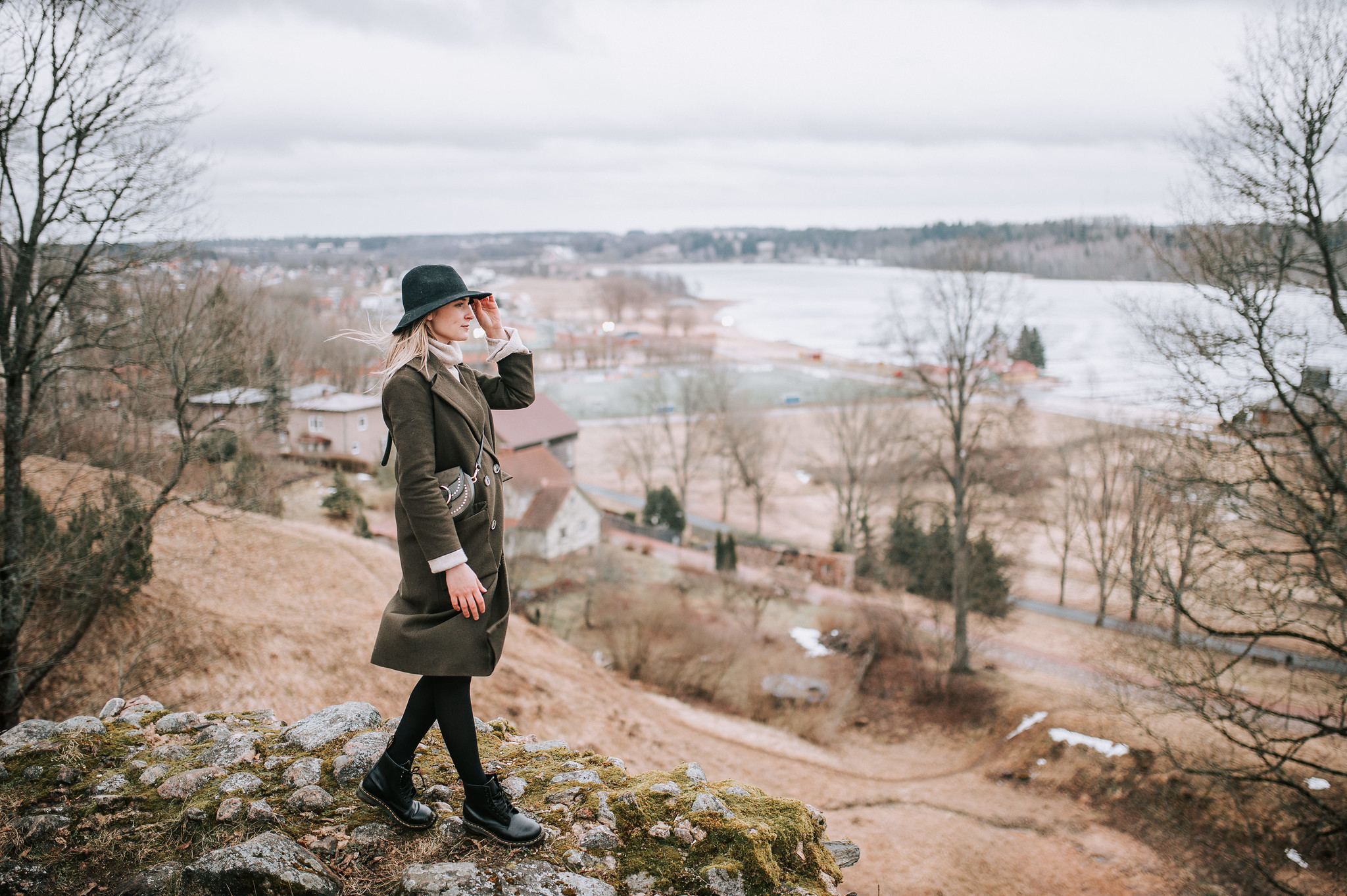 Woman looks out over Lake Viljandi during autumn