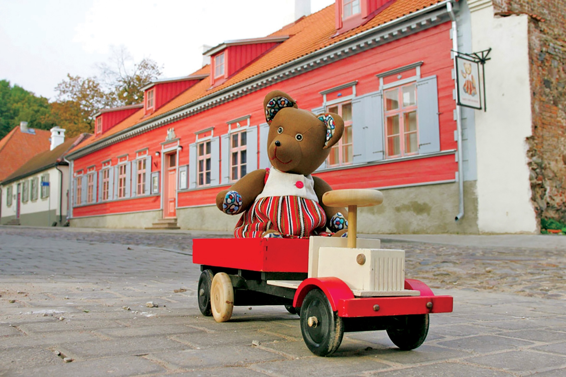 Toy bear sitting in wooden toy truck at Toy Museum in Tartu