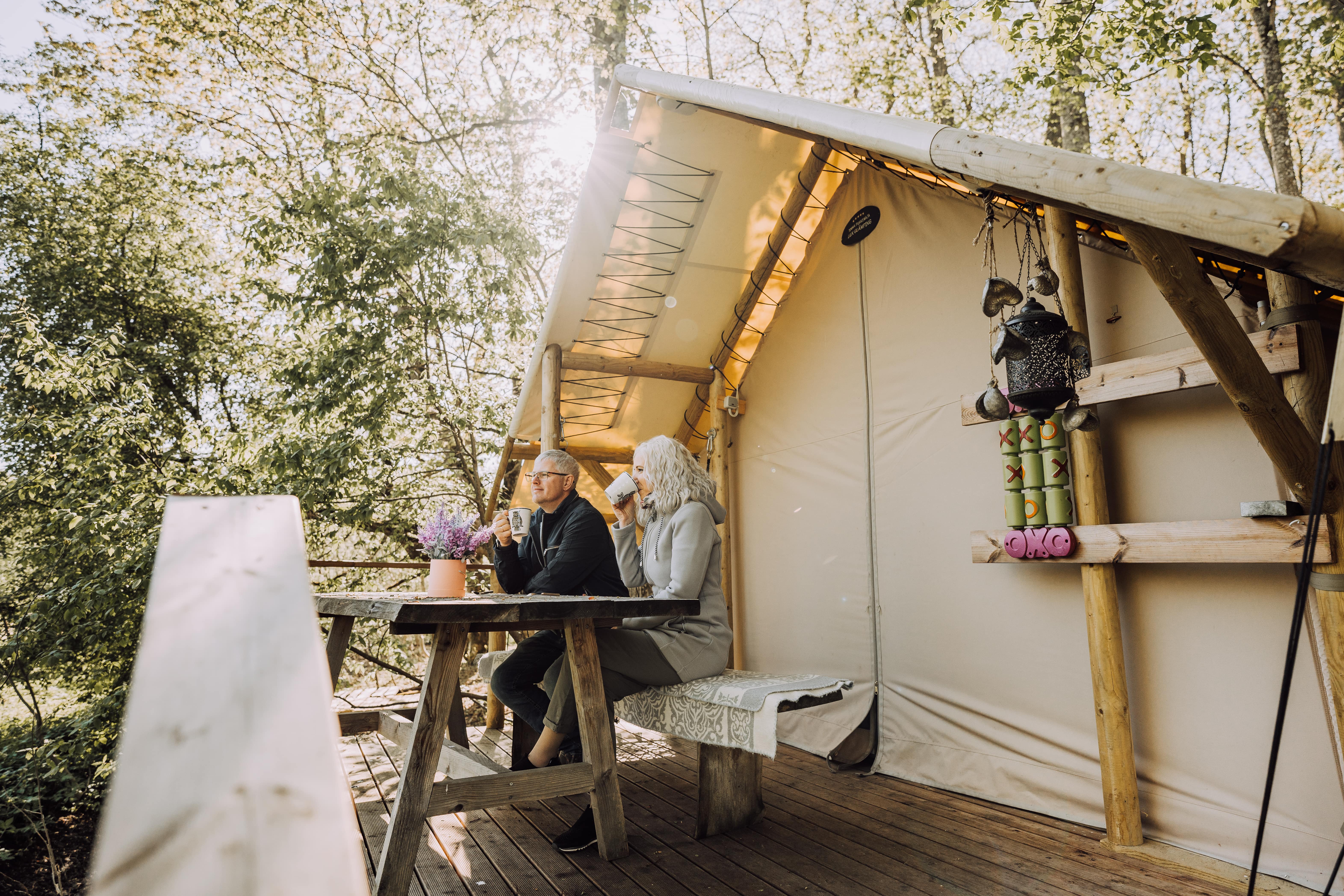 Couple enjoys morning coffee at glamping site in Estonia