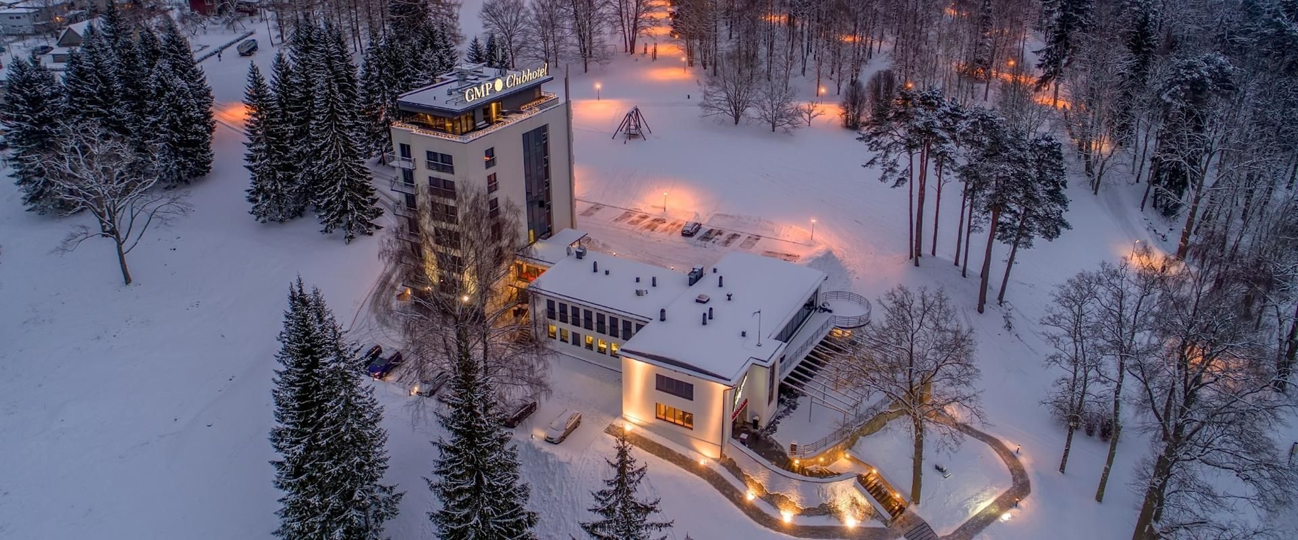 GMP Clubhotel at night covered in snow during winter