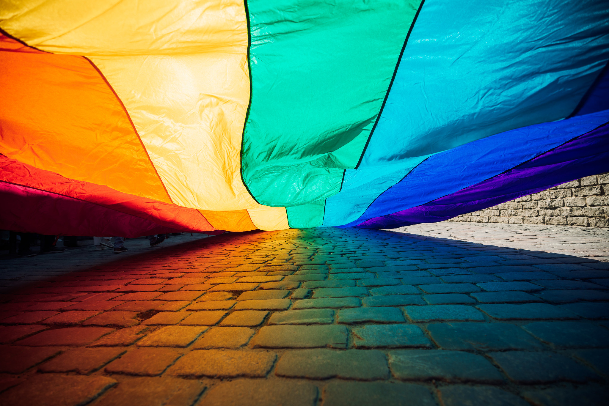 Rainbow flag for Pride parade over cobblestone in Tartu