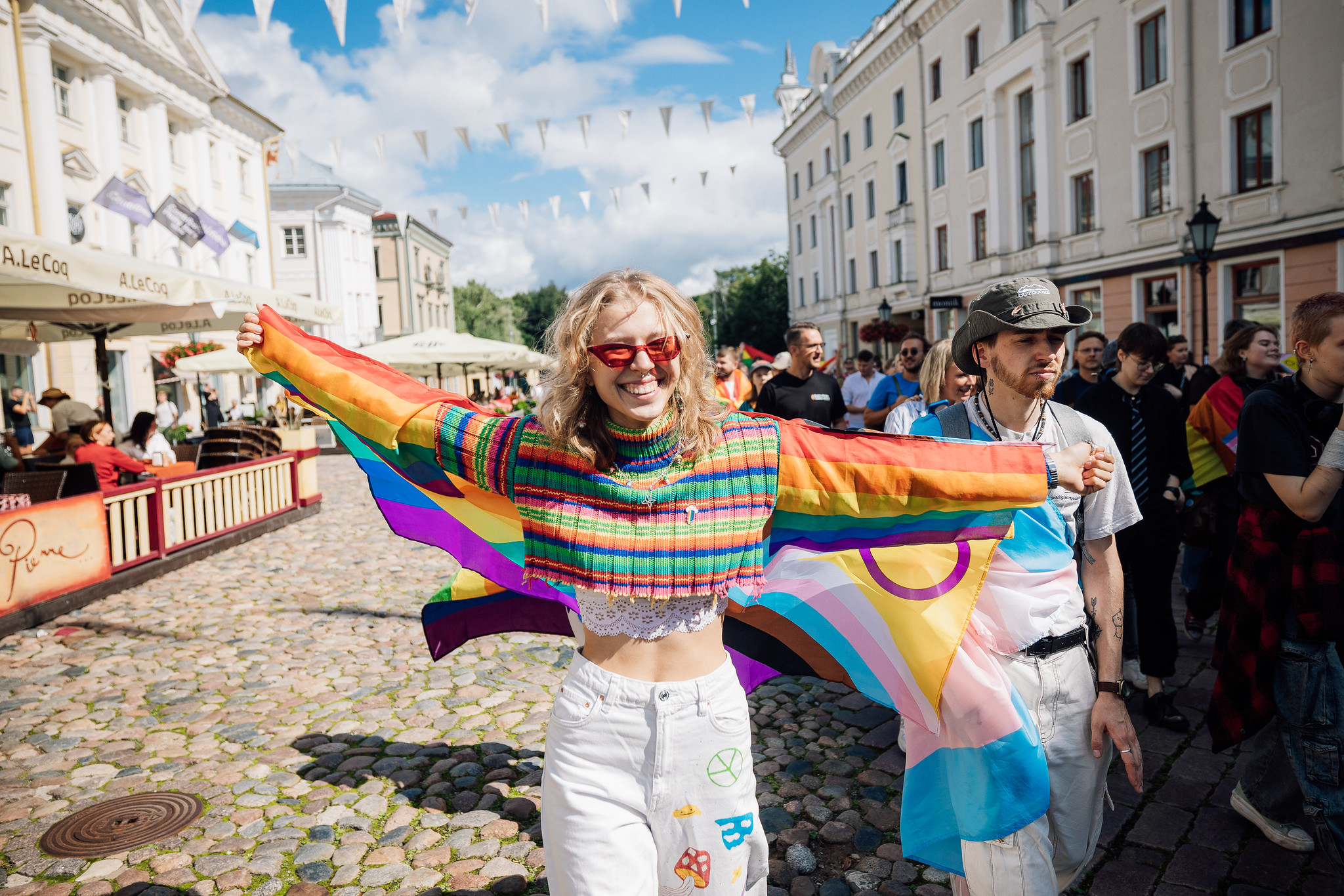 Tartu 2024 Pride parade girl in colorful sweater with flag