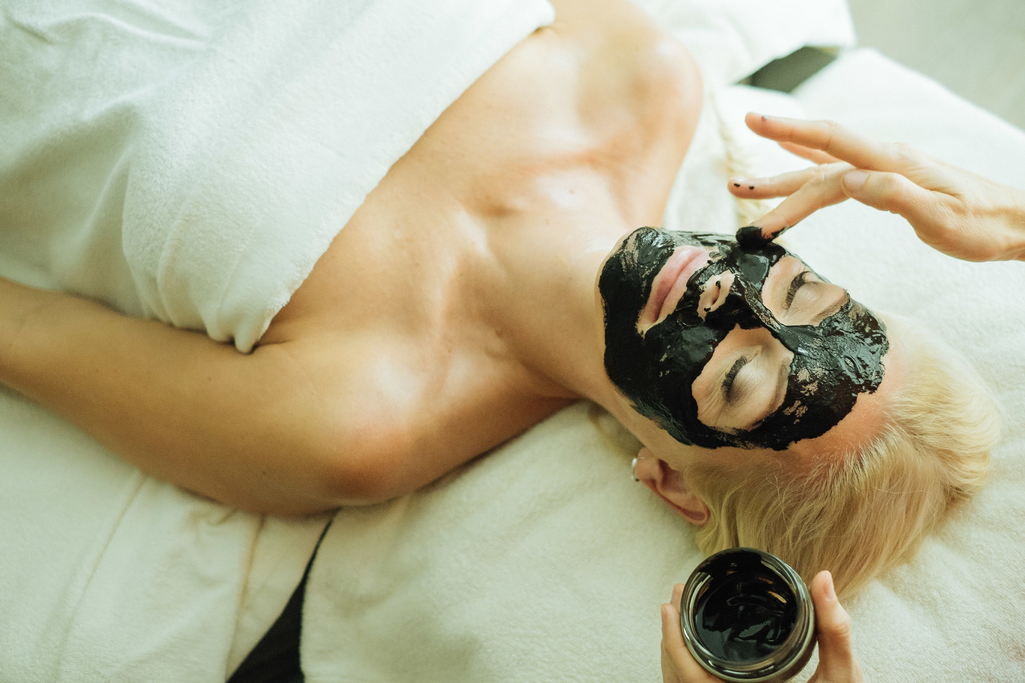 Women receiving mud facial at Estonian spa