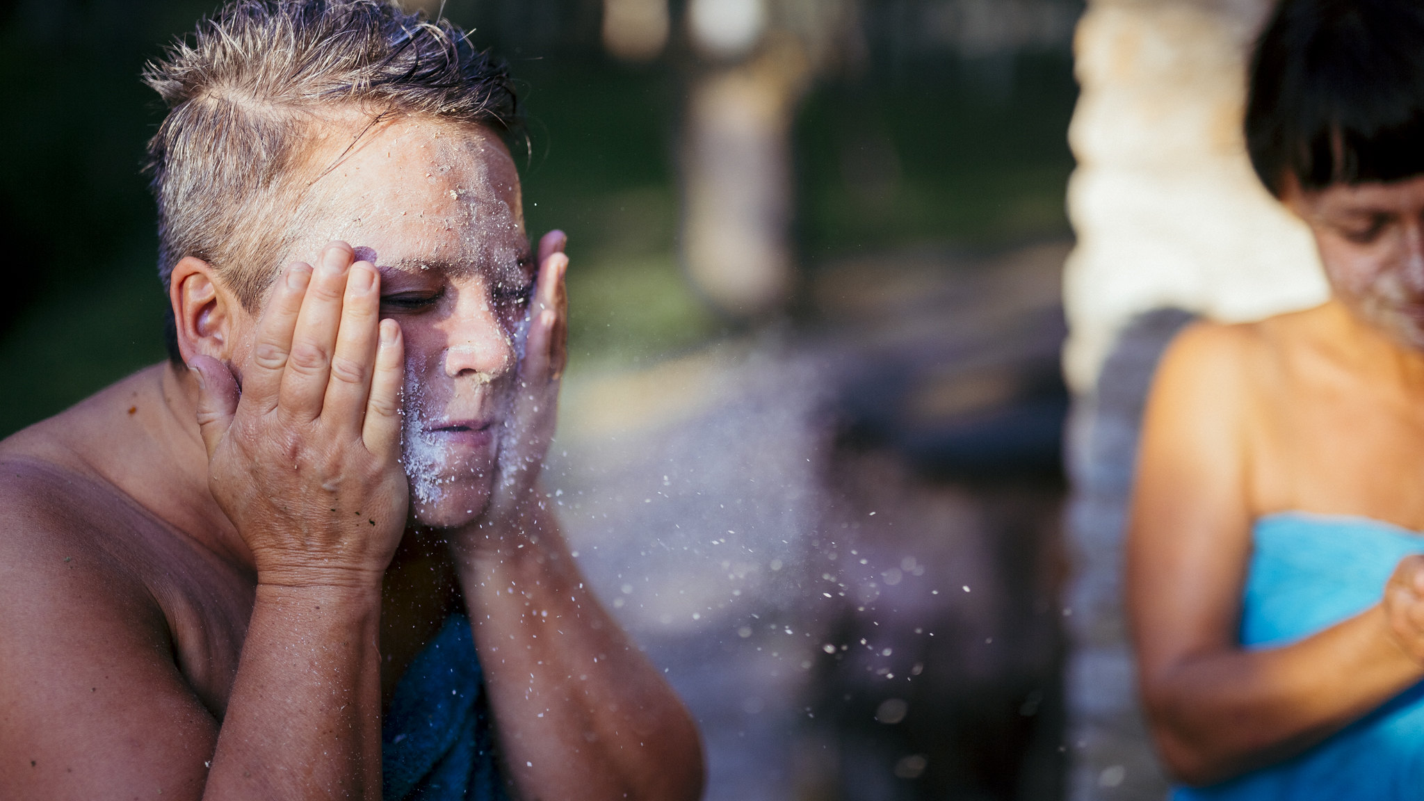 Woman uses ash for exfoliation during Estonian sauna ritual