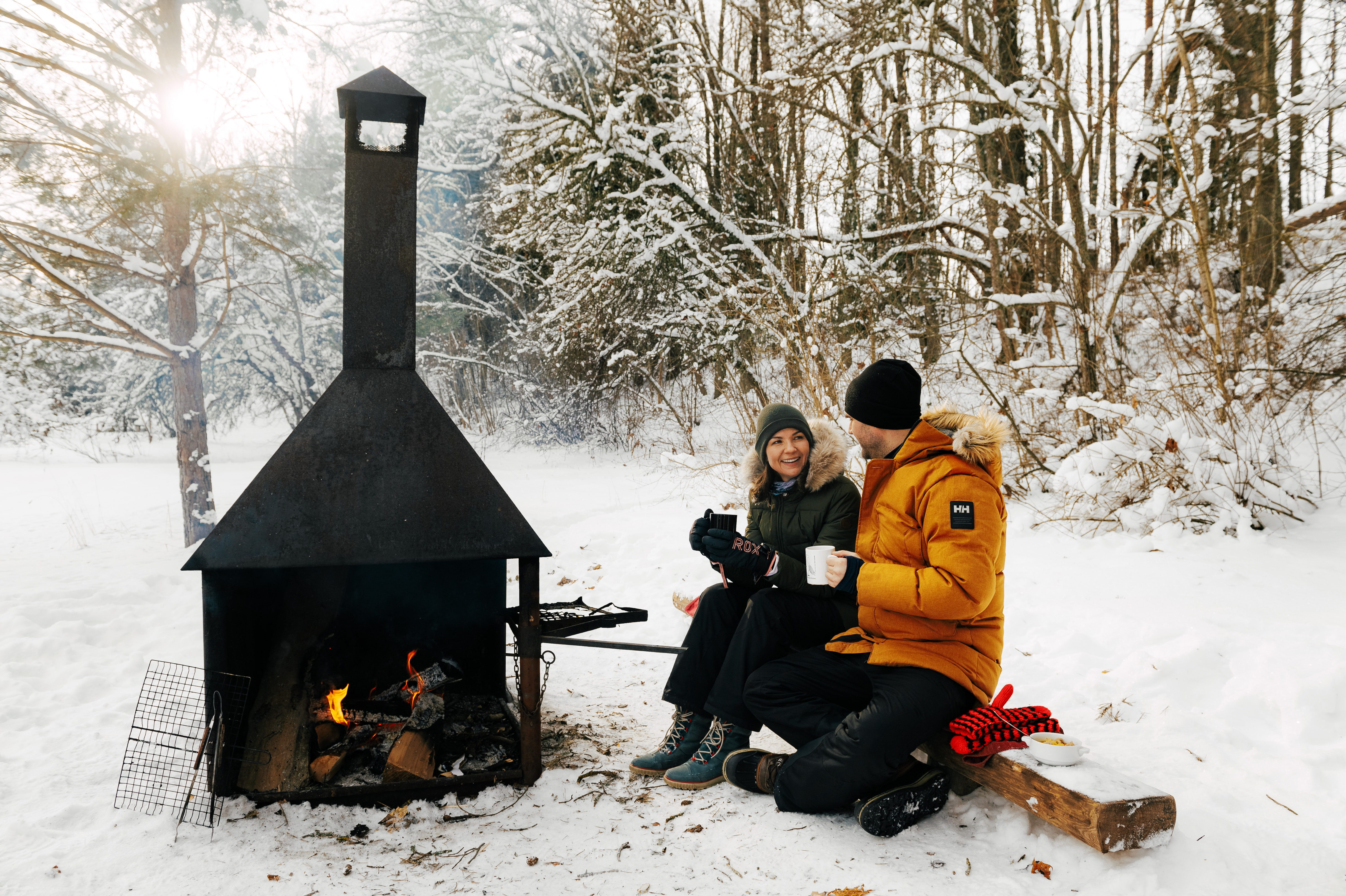 Couple enjoys hot drink in a camping place