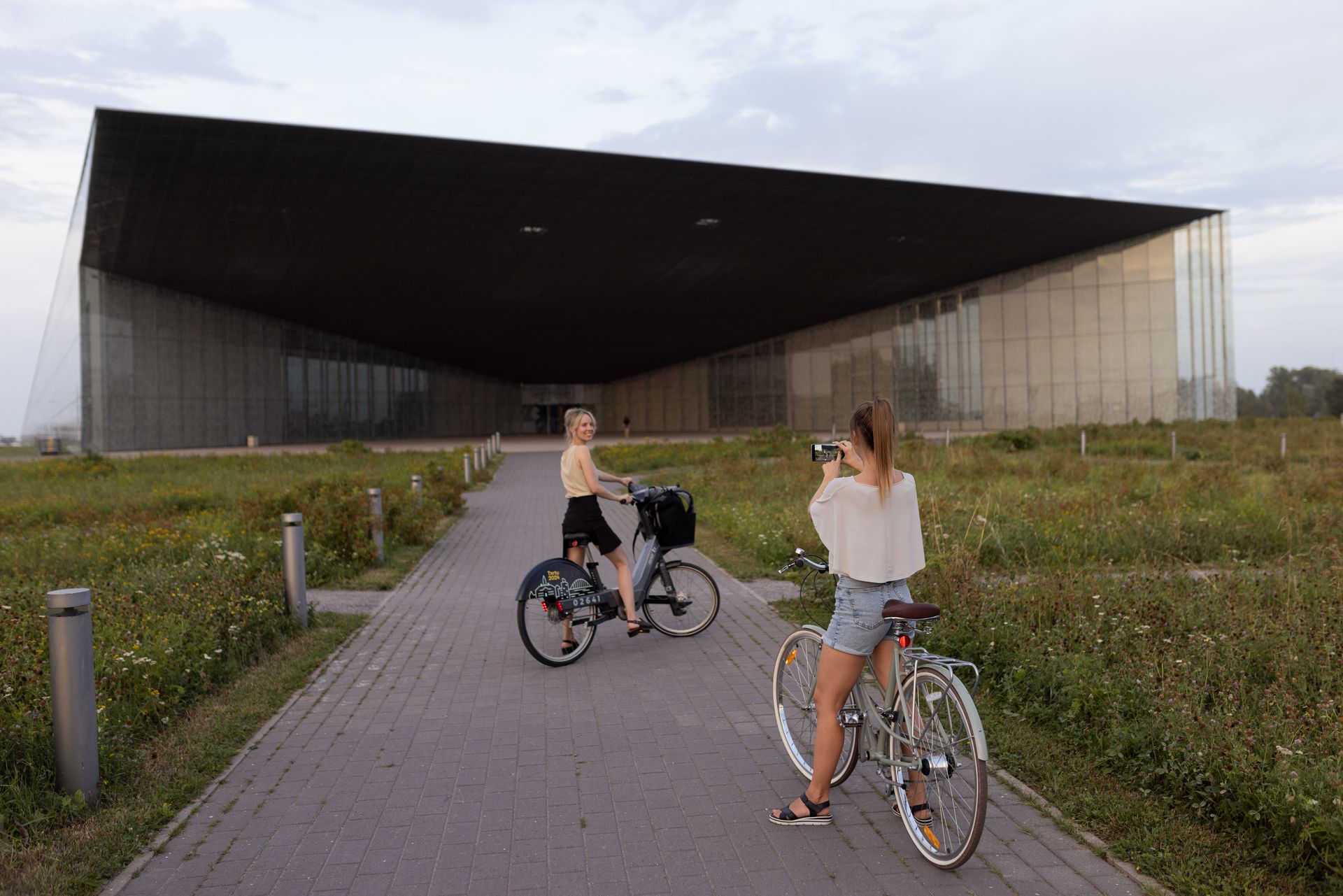 Estonian National Museum with two girls on bikes