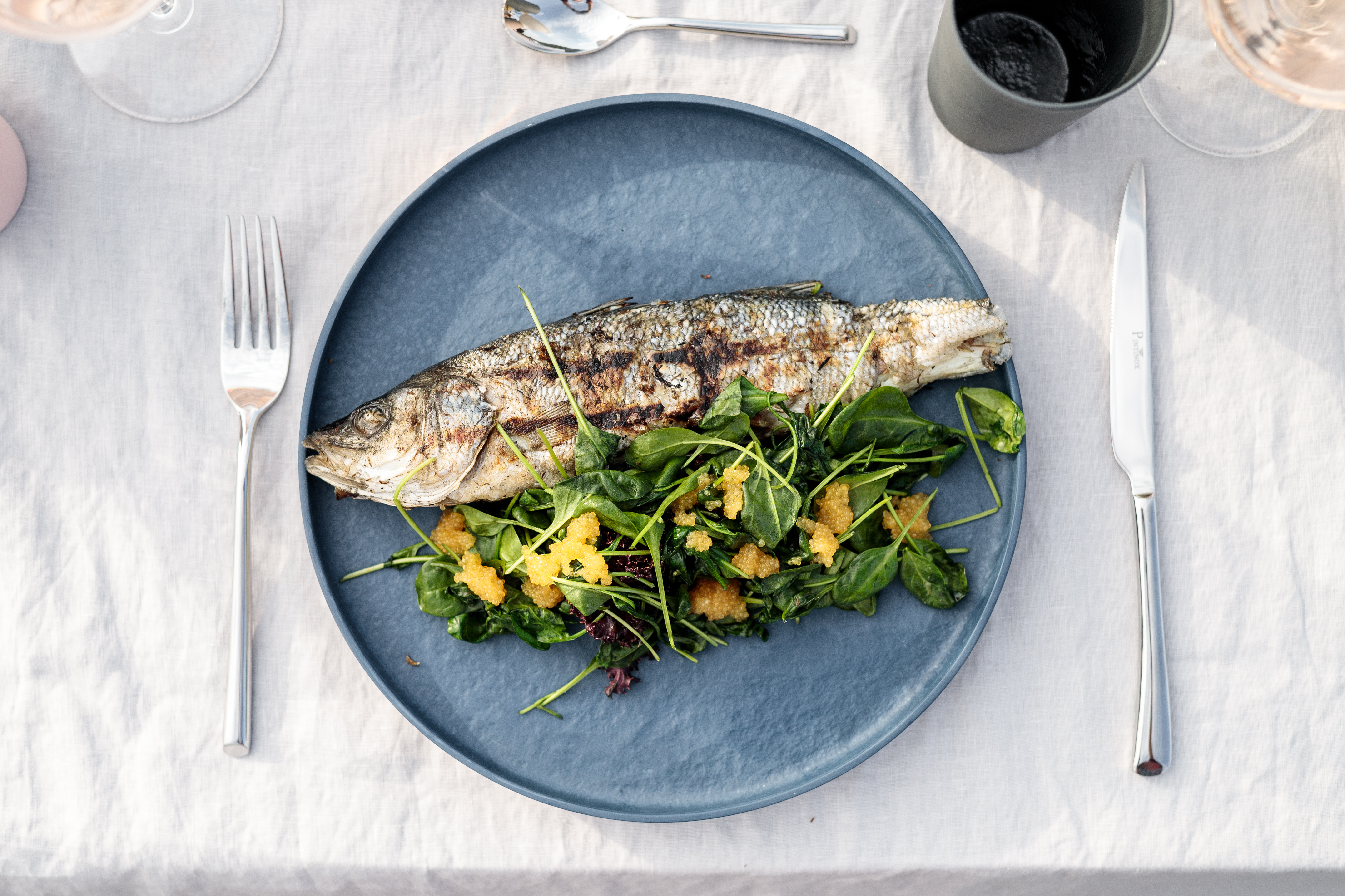 Meal of grilled fish and salad