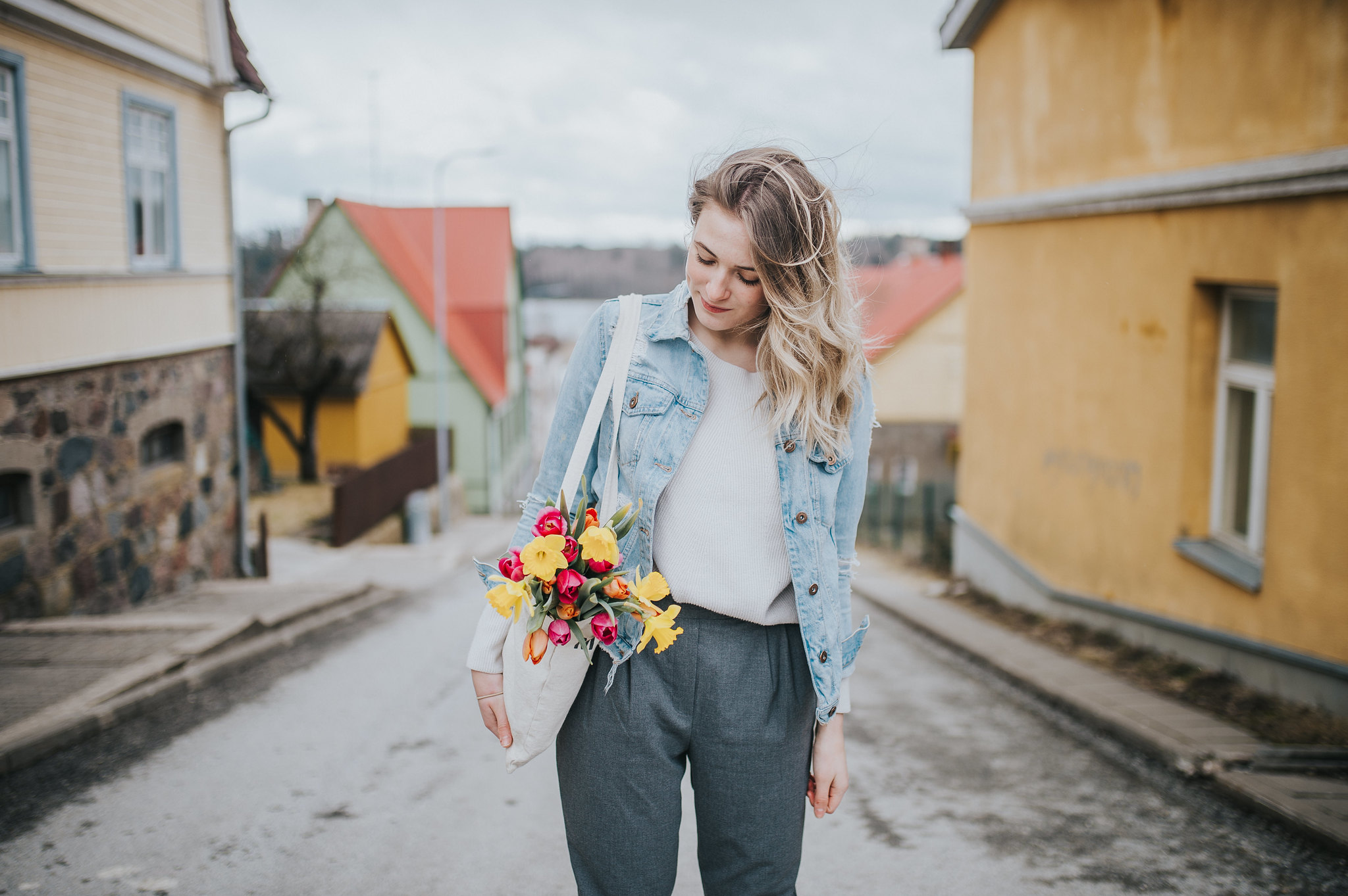 Woman with spring tulips in a bag in Viljandi, Estonia