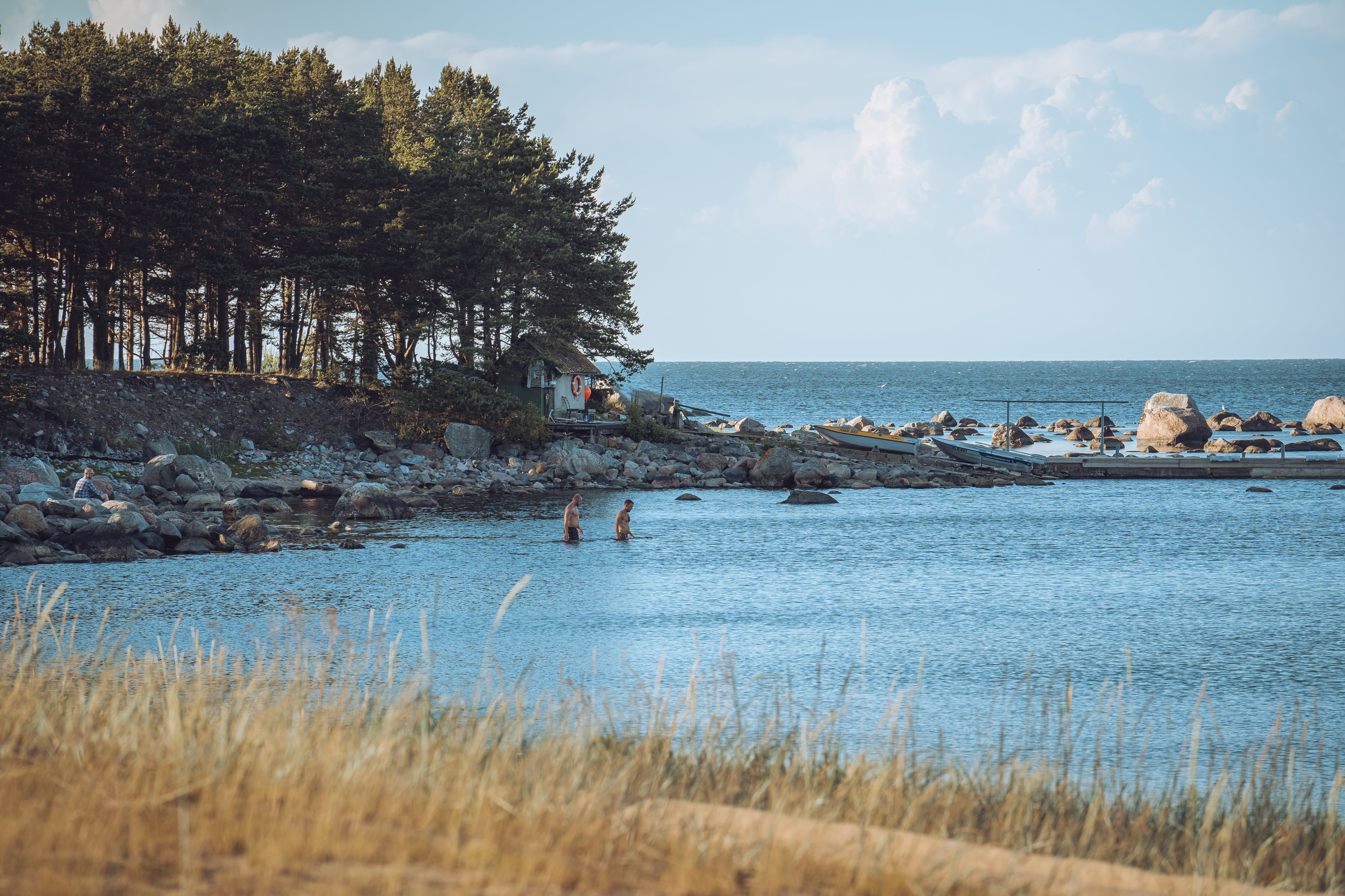 Men swimming on Prangli Island in Estonia during summer