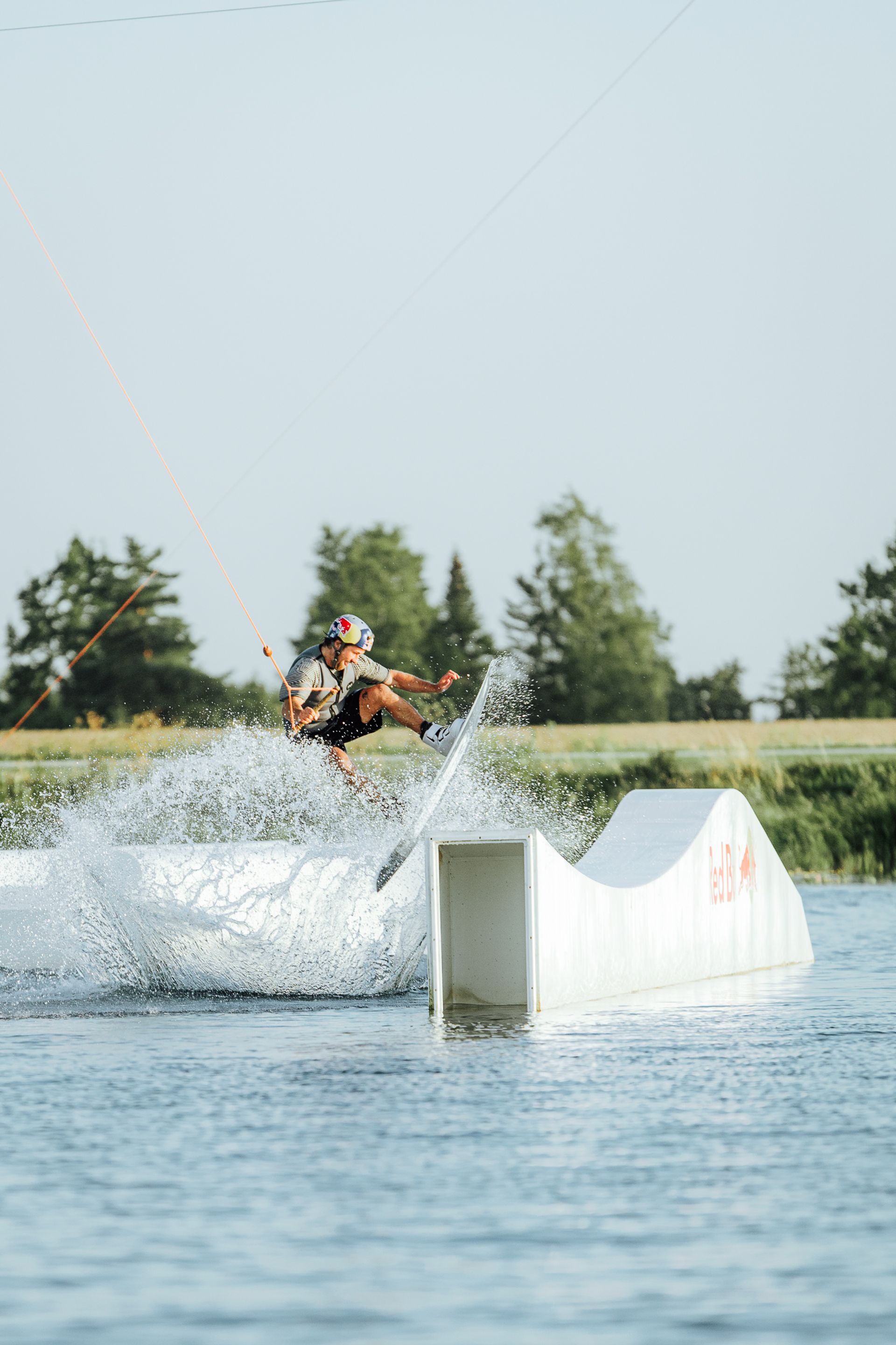 Man jumps on a wakeboard on a lake in Estonia