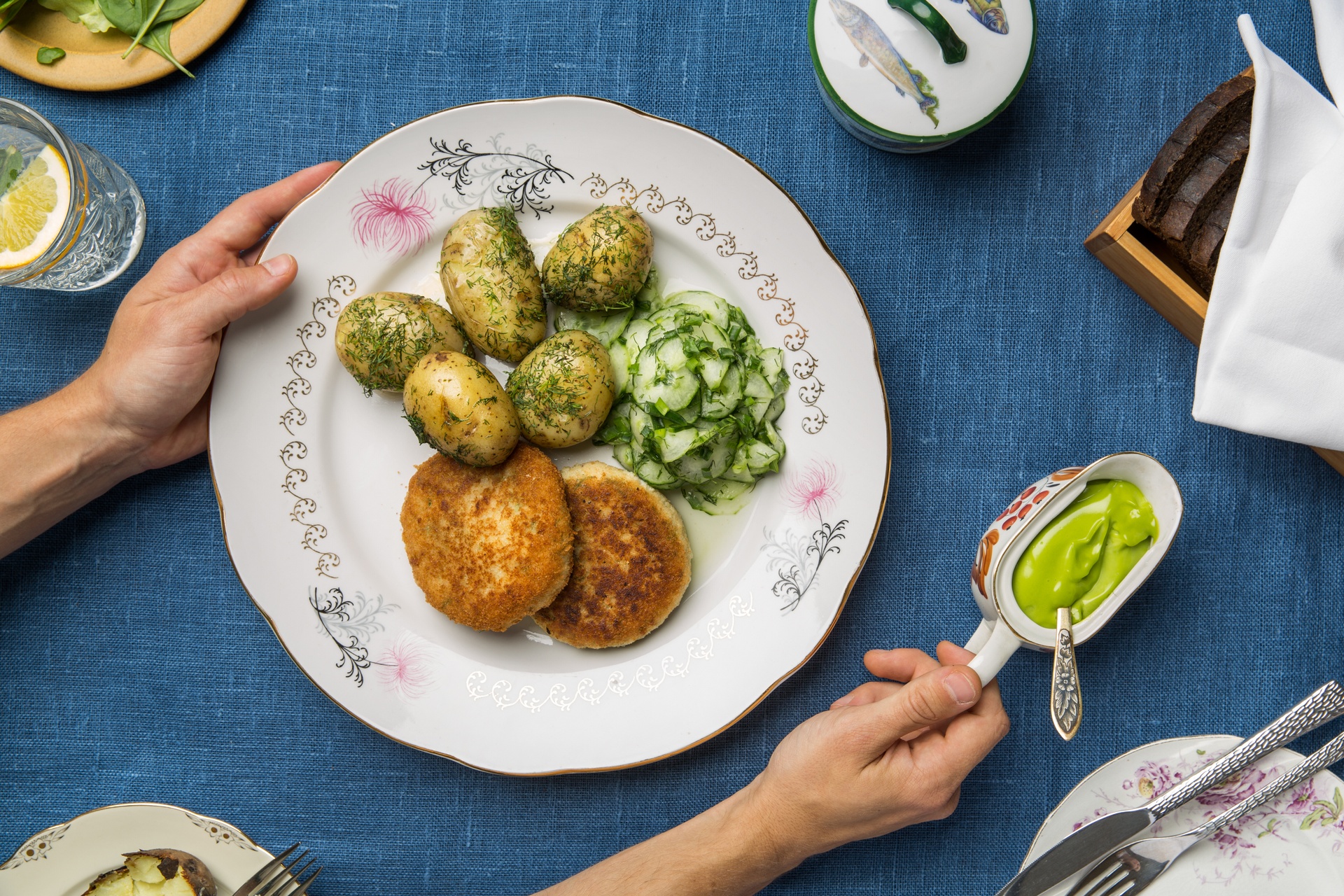 Fish cutlets, boiled potatoes and cucumber salad