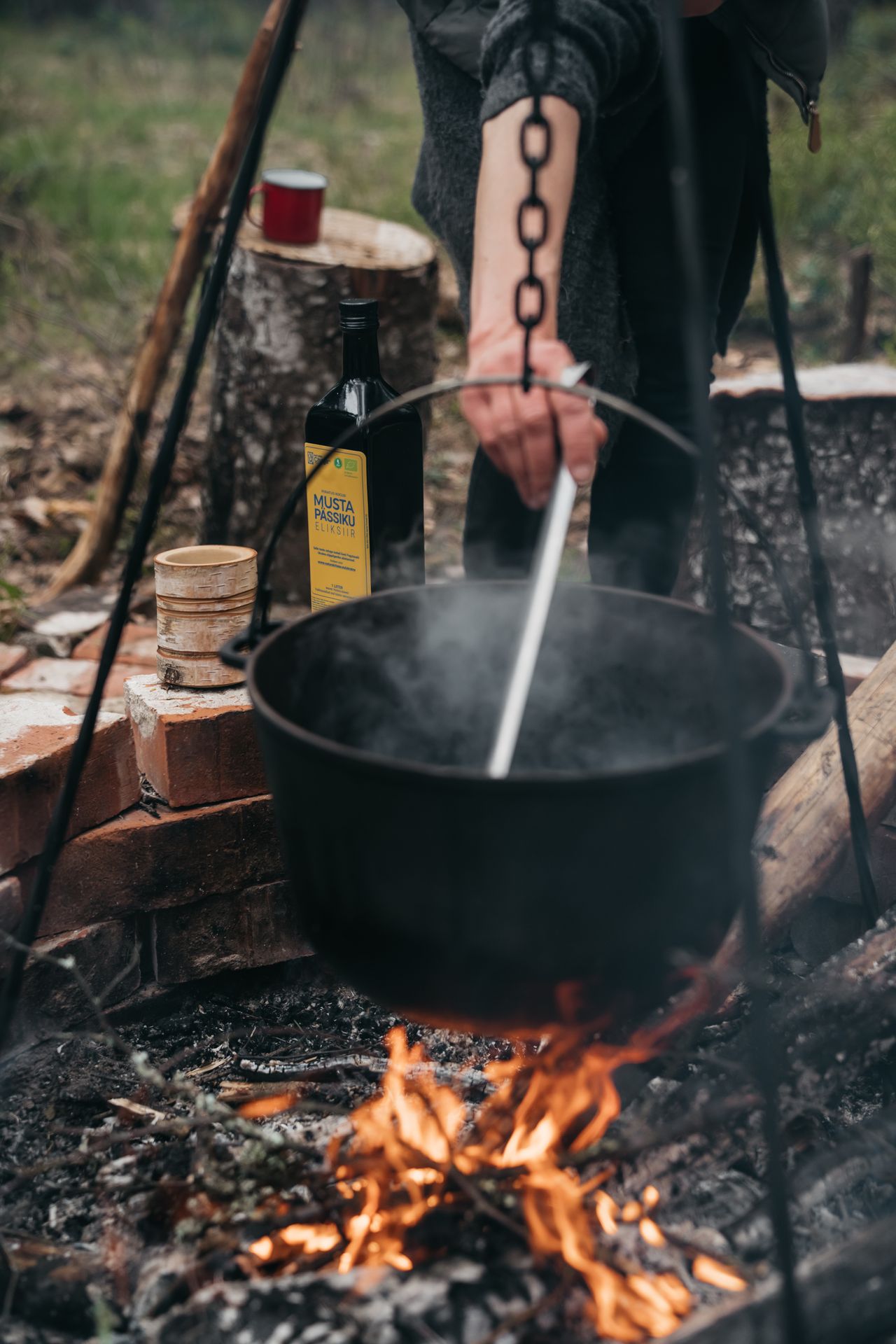 Man makes traditional Estonian food over an open fire