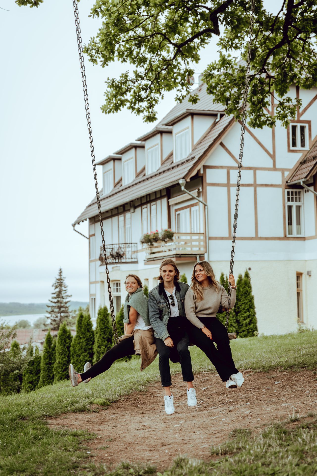 Women on swing by oak tree in Viljandi in Central Estonia
