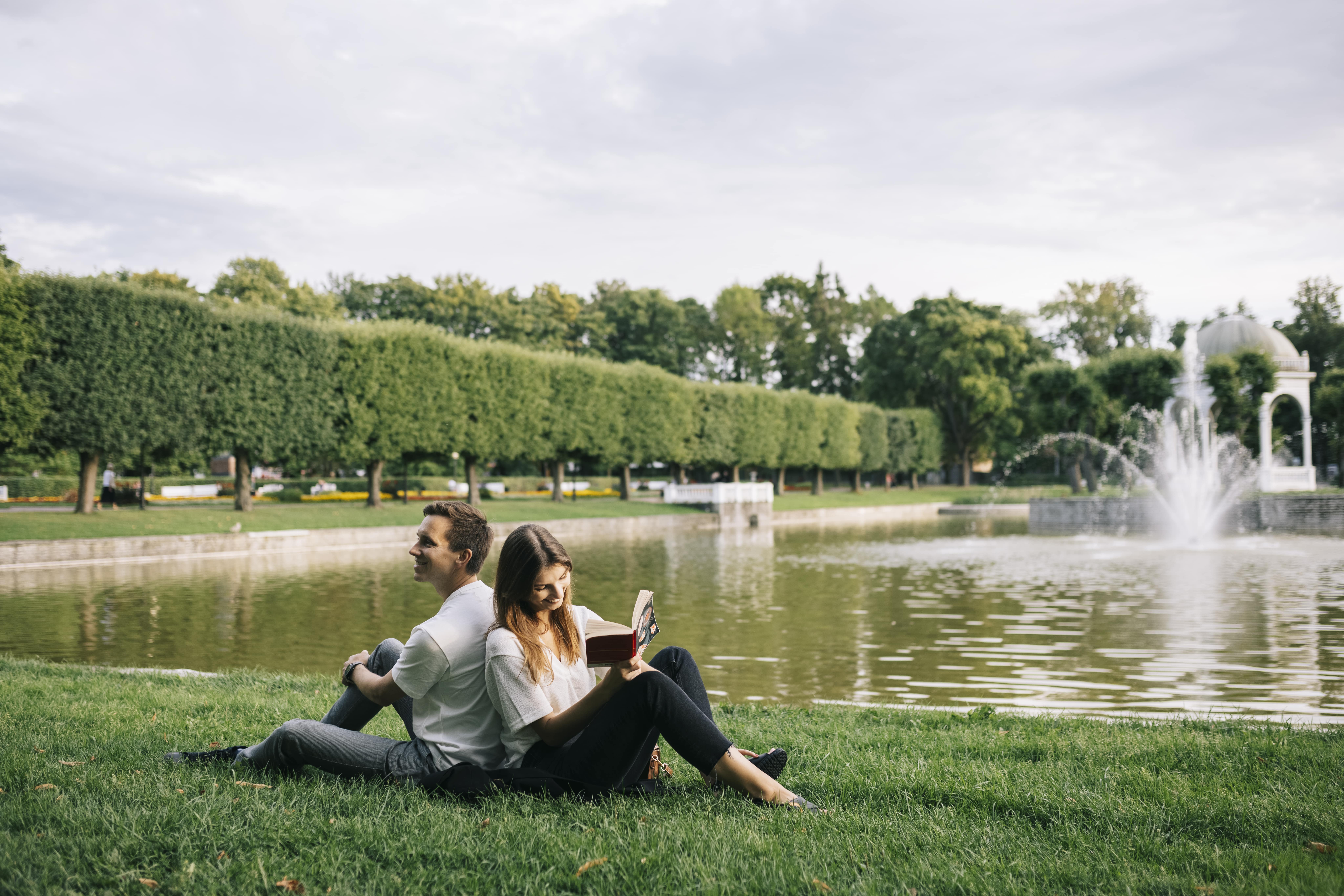 couple reading and relaxing in Kadriorg Park before breakfast in Tallinn