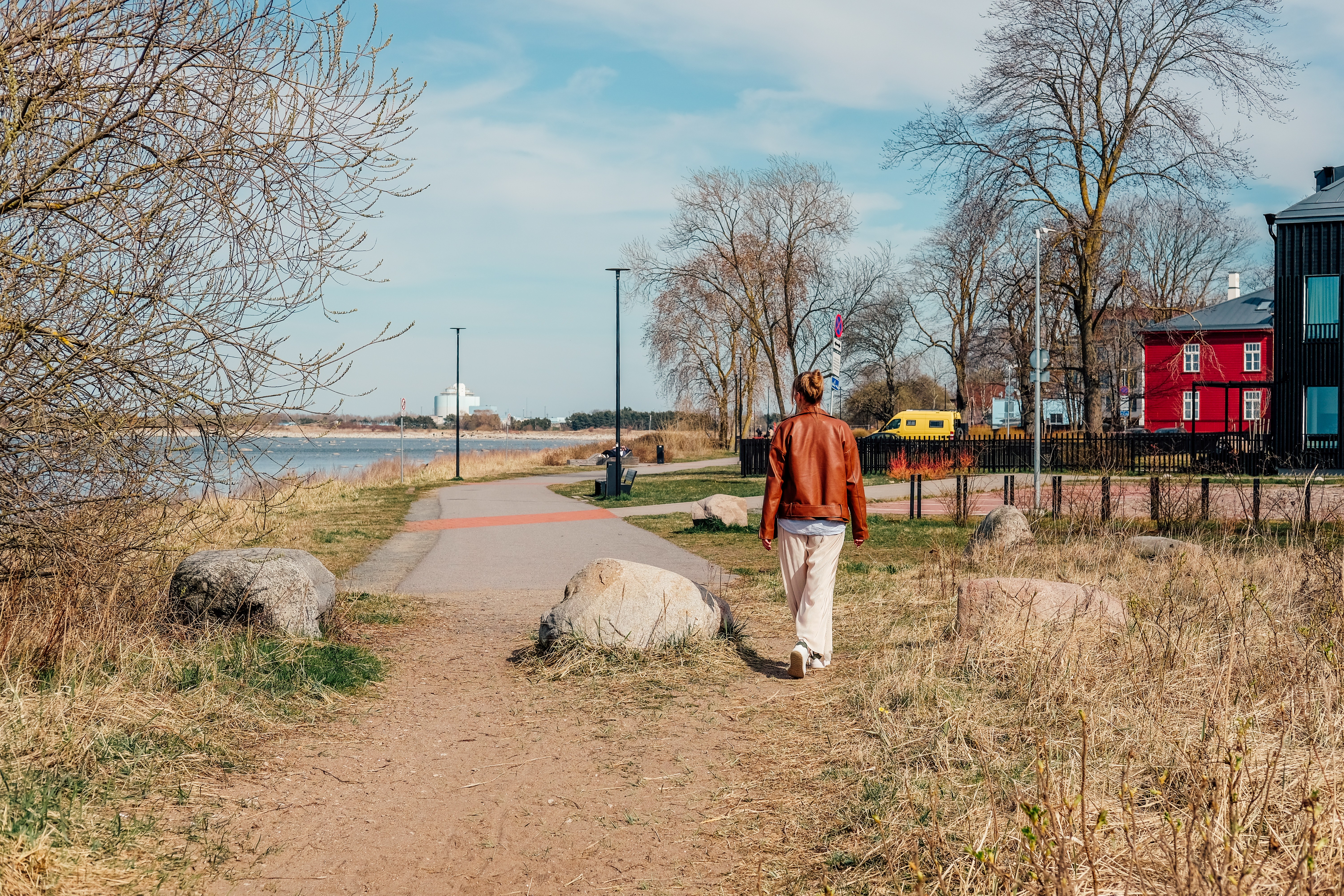 Woman walking on a seaside path in Kopli.