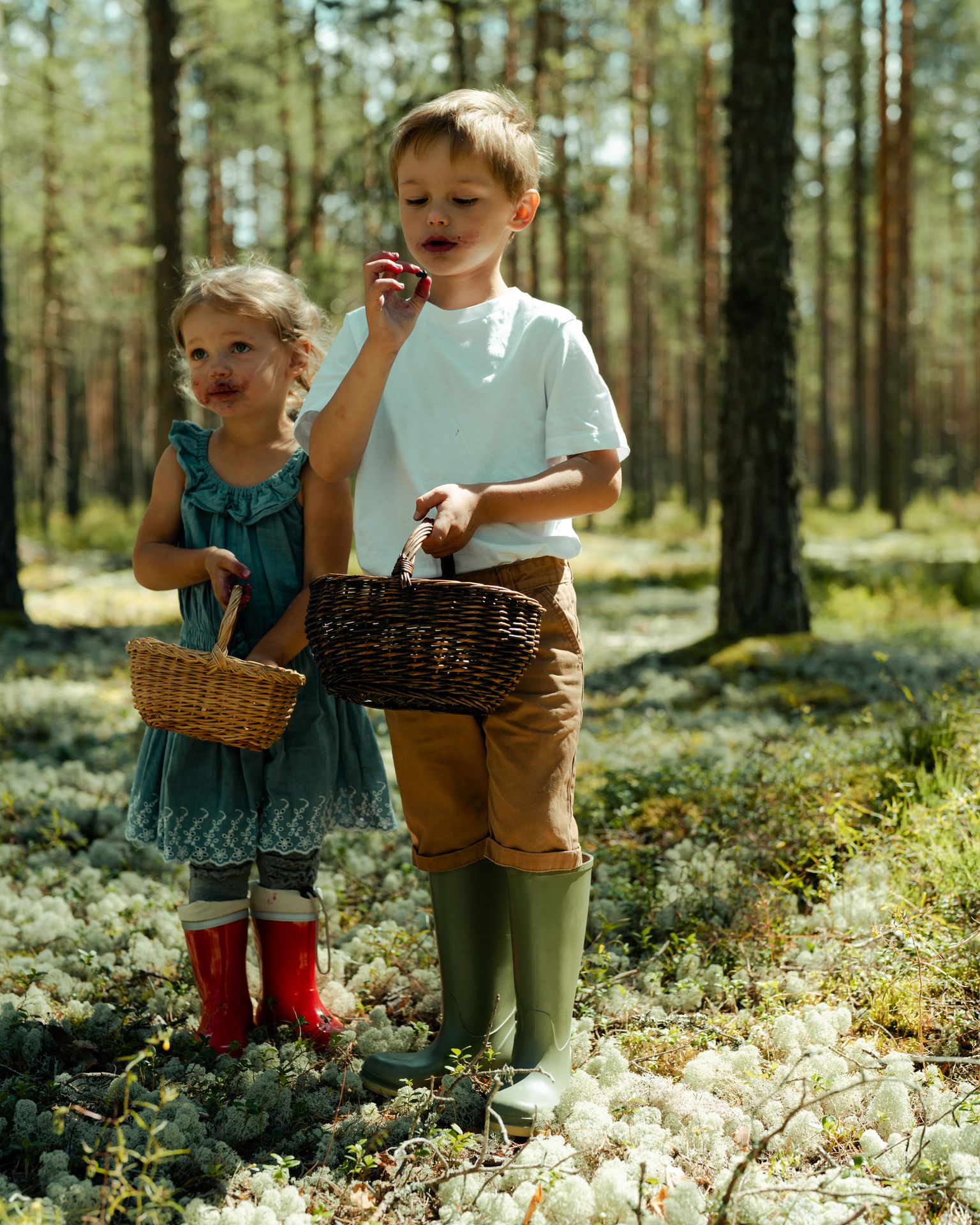 Estonian kids eating wild berries foraged in the forest