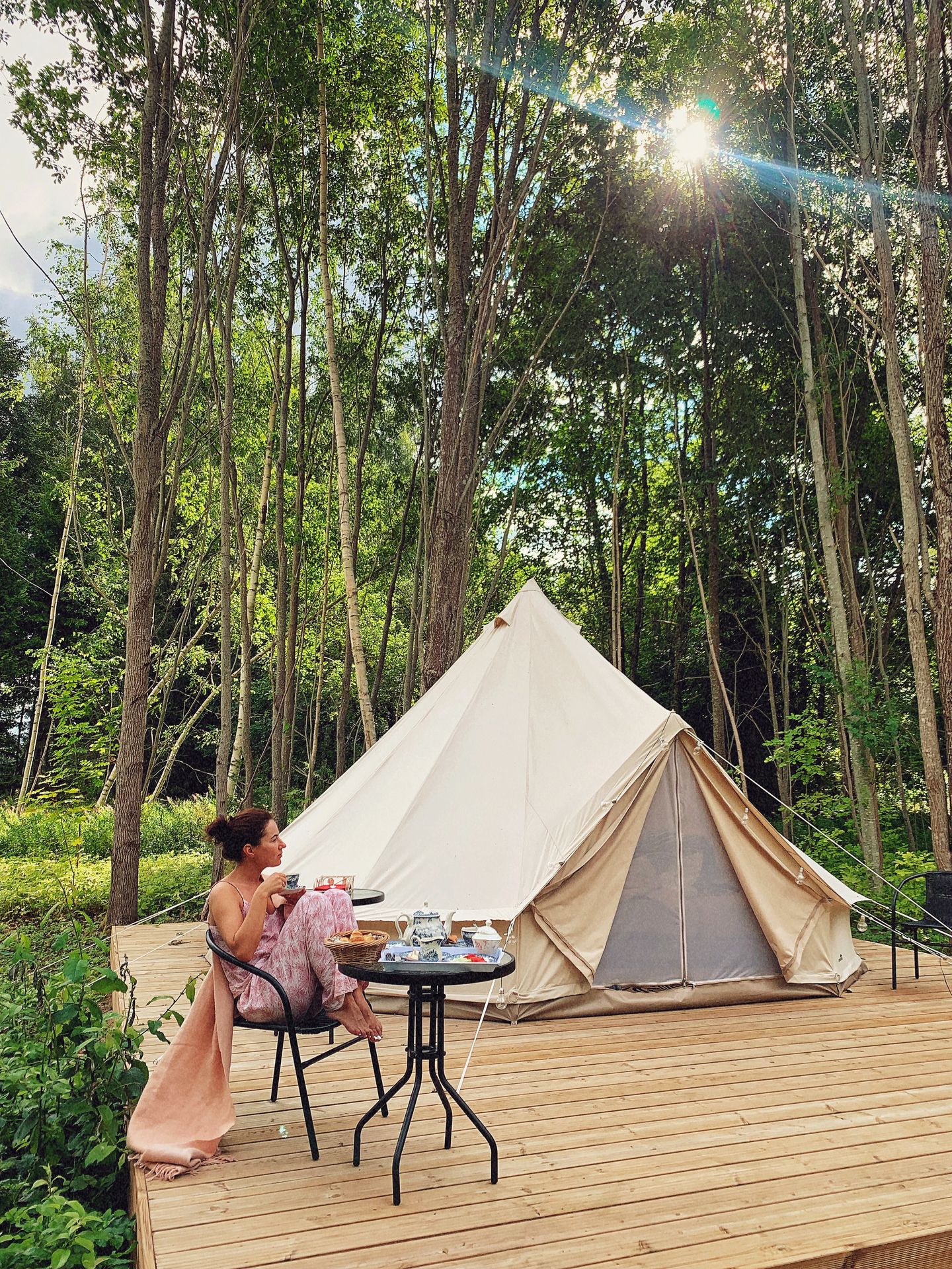 Woman enjoys nature in Estonia by camping in the forest