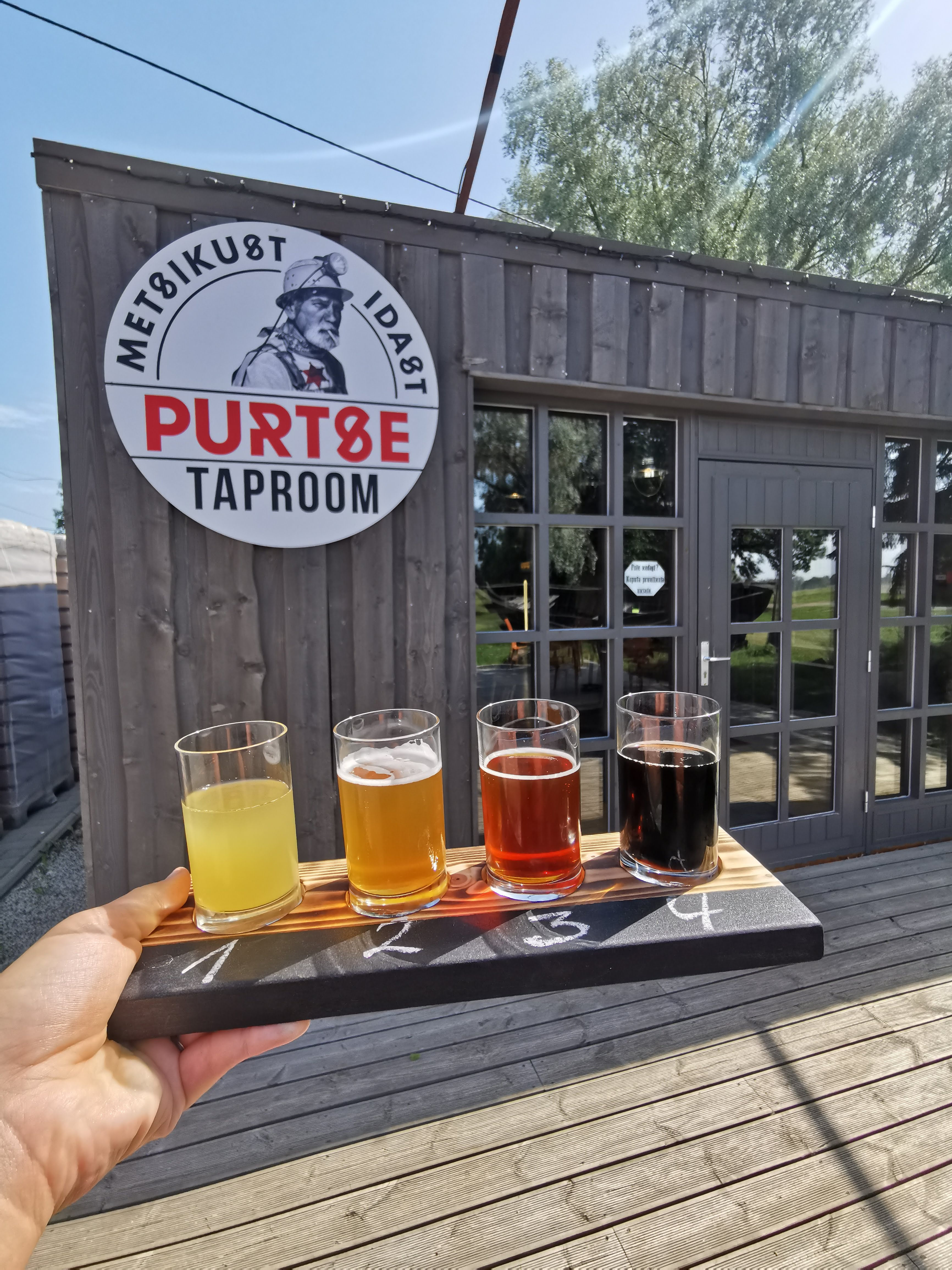 A craft beer tasting tray in front of the Purtse Brewery in North Estonia