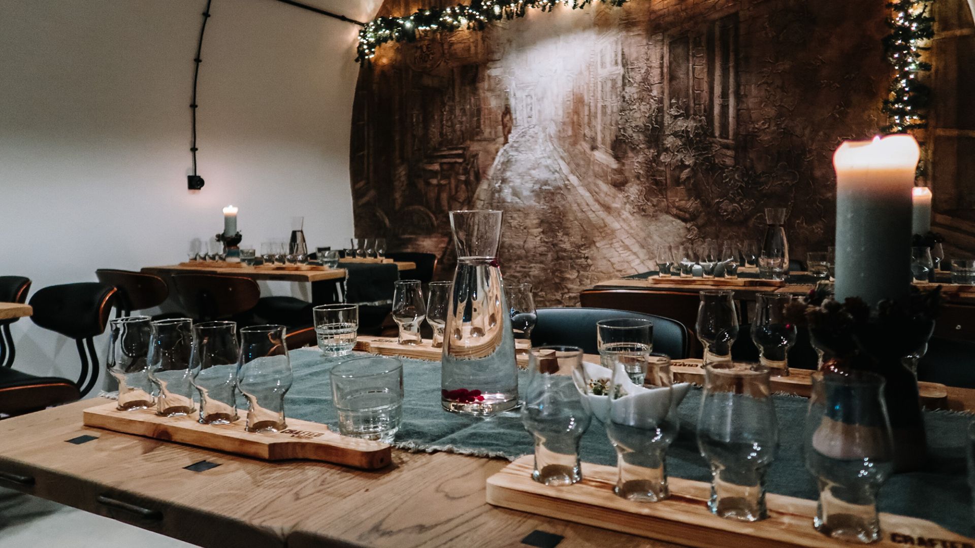 Tasting room at distillery in North Estonia with glasses and a painting on the wall