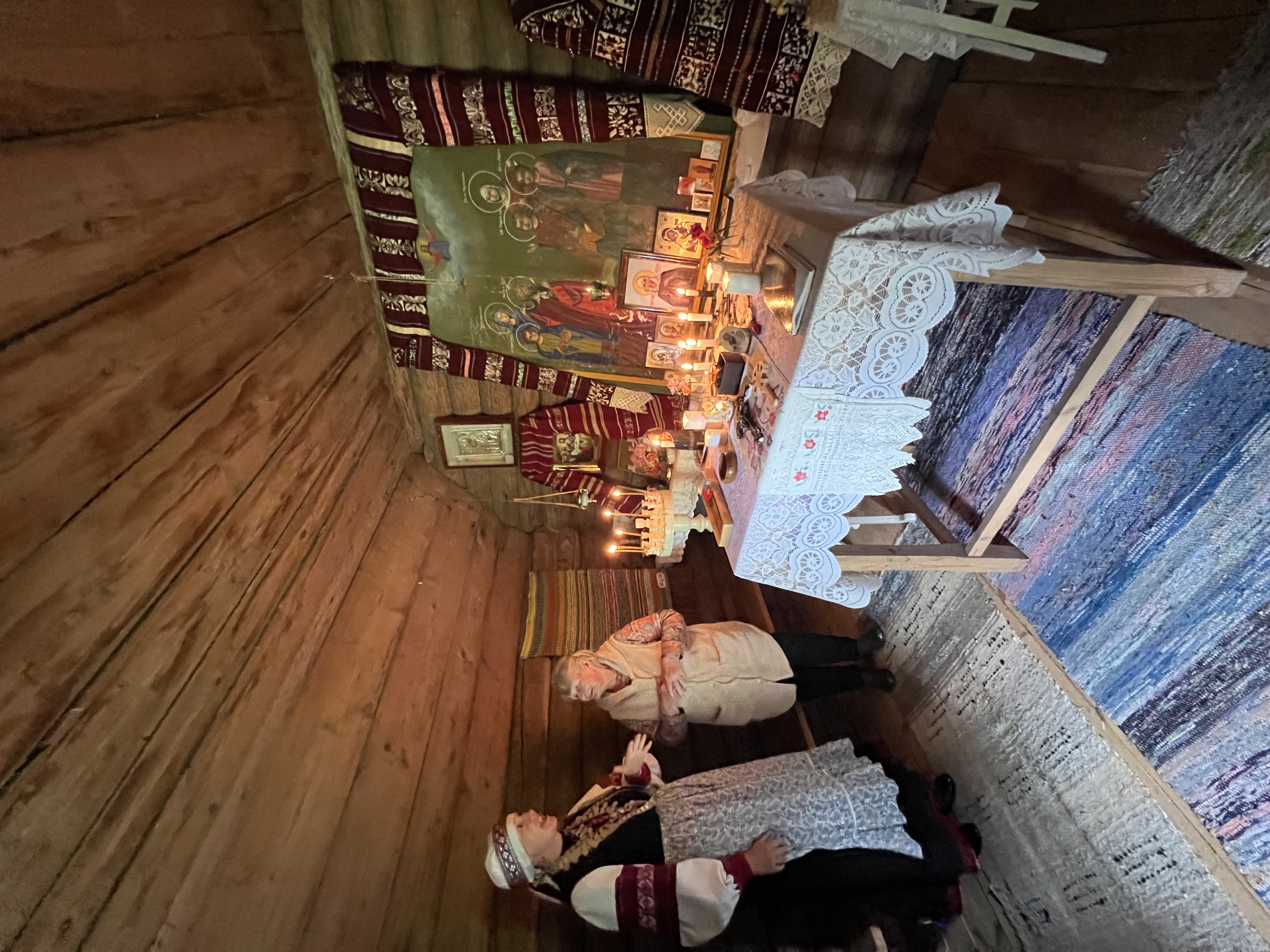 Tour guide and chapel caretaker chat in Serga tsässon in Setomaa, South Estonia