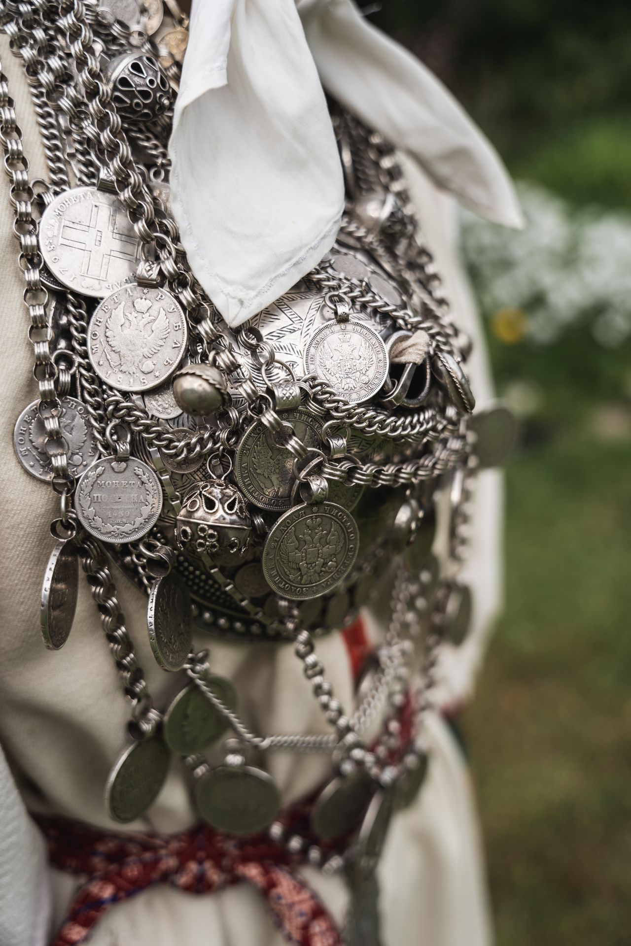 Close-up of silver coins and chains worn by a Seto woman in South Estonia