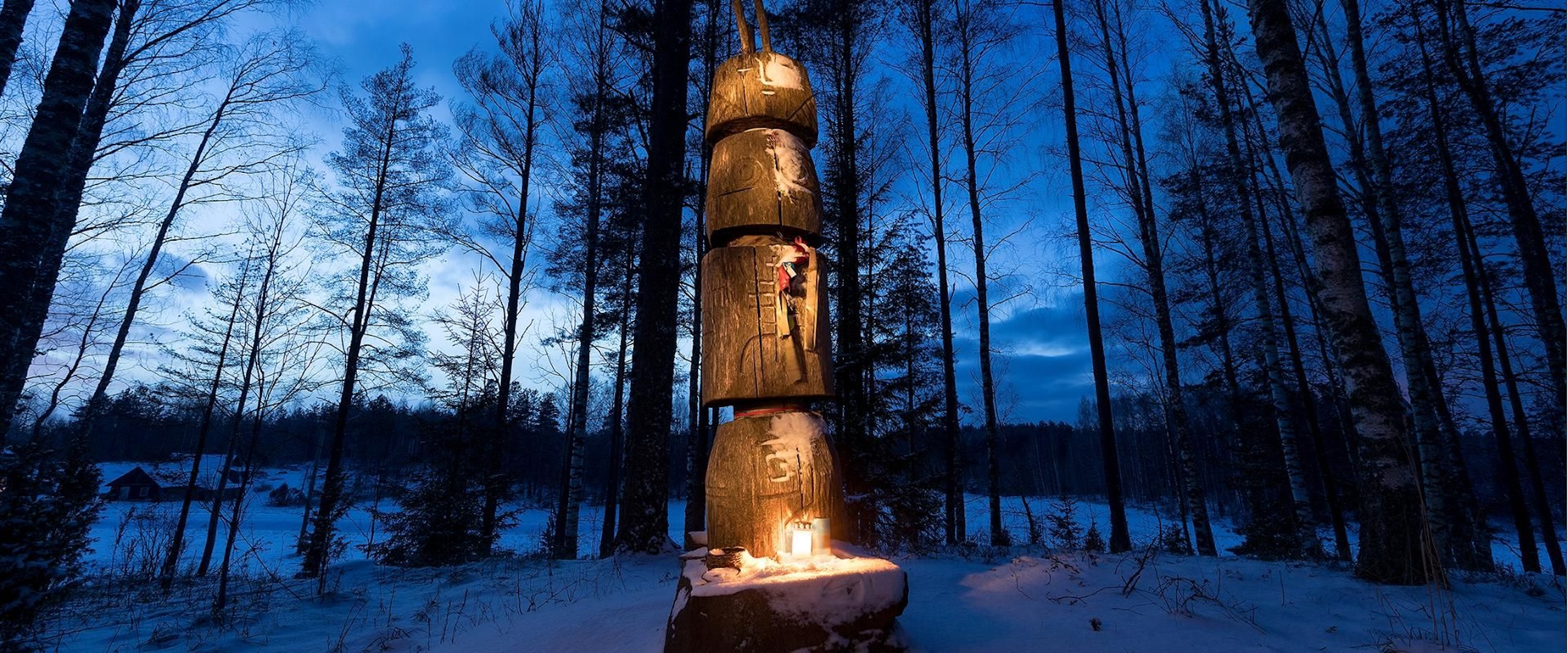 Statue of Peko on a winter evening with offerings in Setomaa, South Estonia