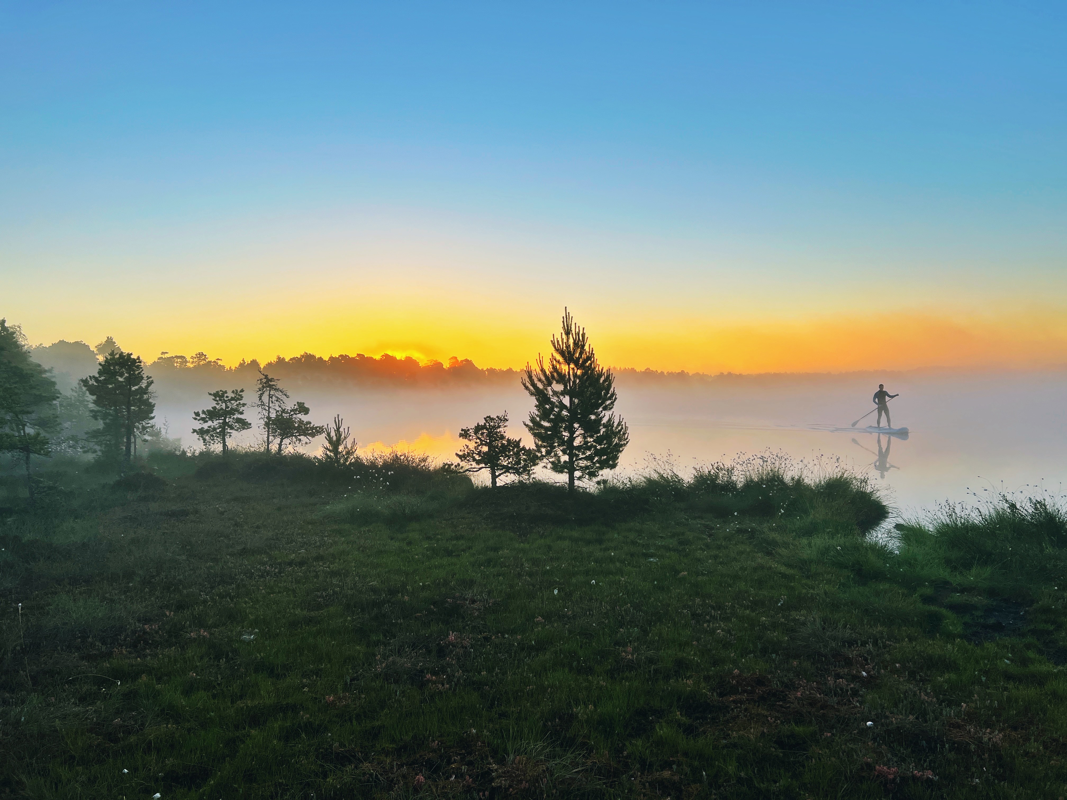 A paddleboarder on a misty morning at Lake Kakerdaja