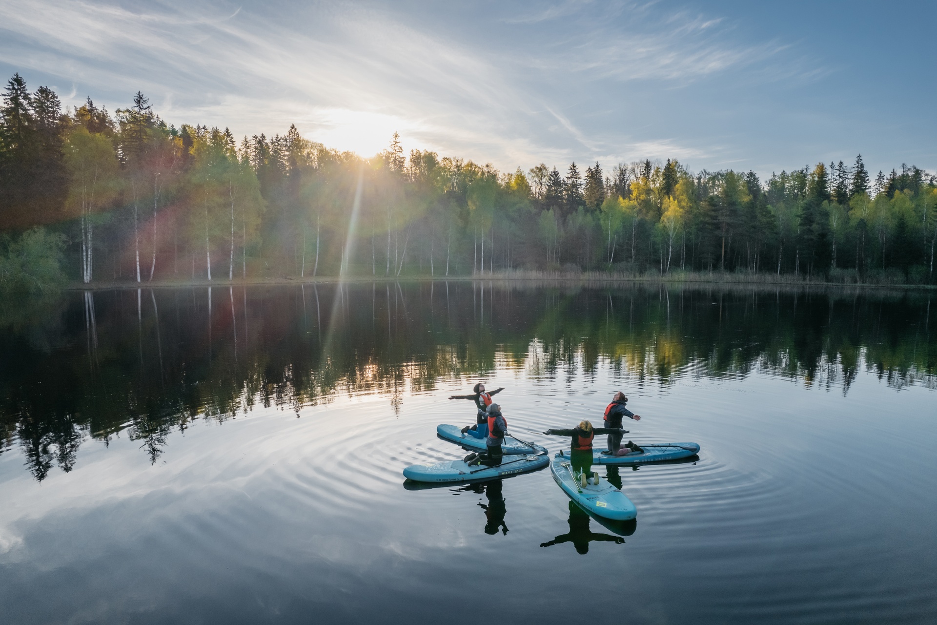 Sup-board yoga on a forest lake in Estonia