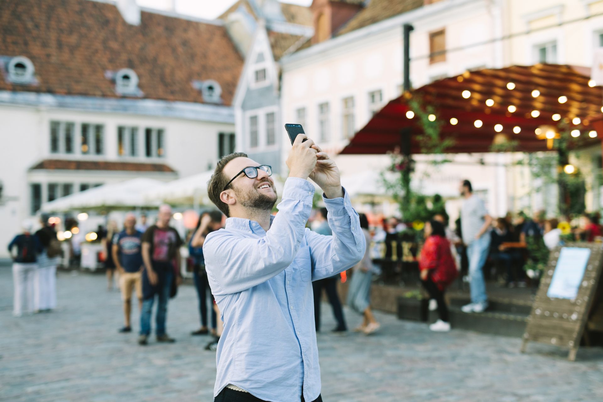 Tourist in Estonia taking photos in Tallinn's Old Town